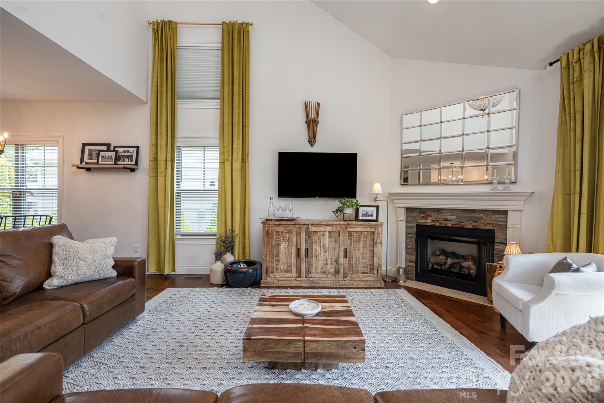 Vaulted great room ceiling with television placement above the fireplace console. - 17 Asher Lane, Arden