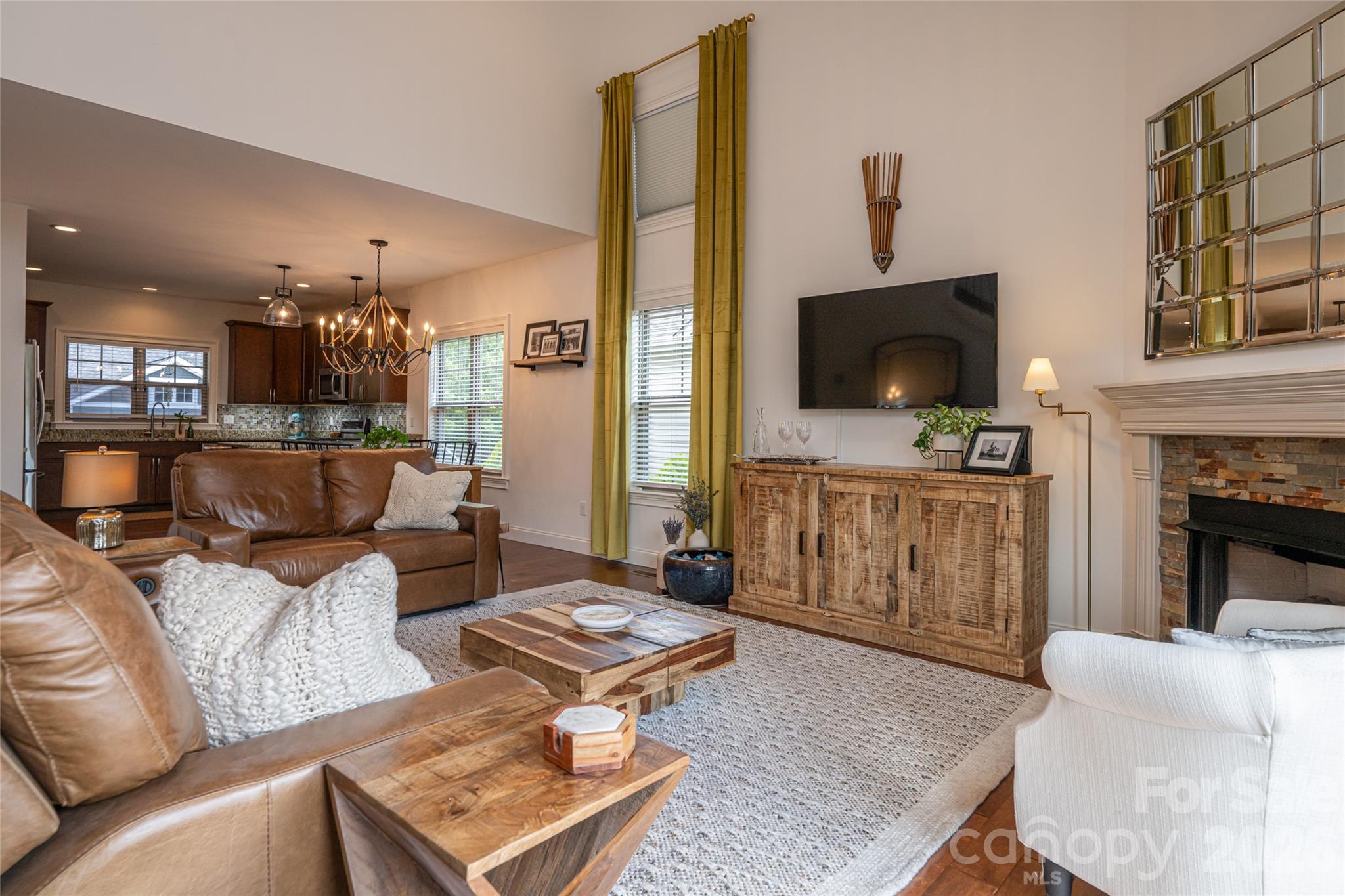 View from the great room toward the kitchen and dining area, showing the open floor plan. - 17 Asher Lane, Arden