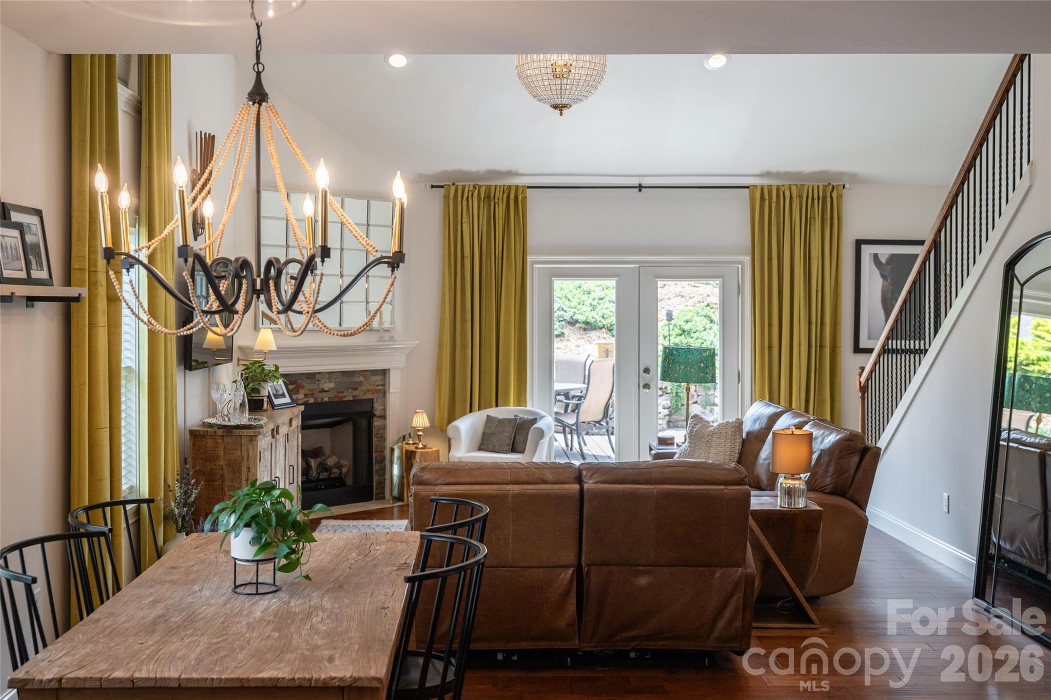 Open-concept great room and dining area anchored by the gas fireplace at the heart of the main level. - 17 Asher Lane, Arden