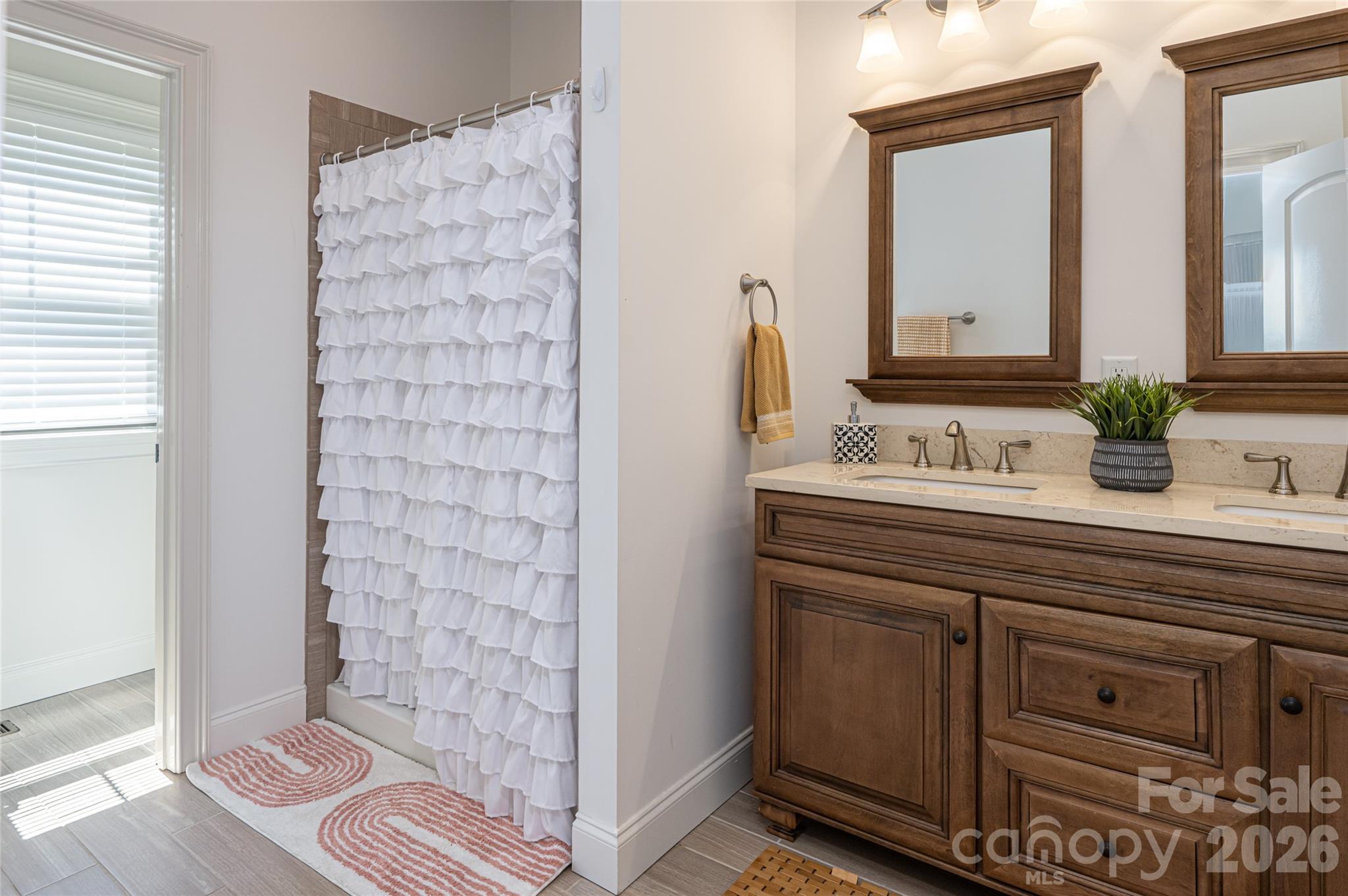 Primary bath shower and extended vanity with generous storage. - 17 Asher Lane, Arden
