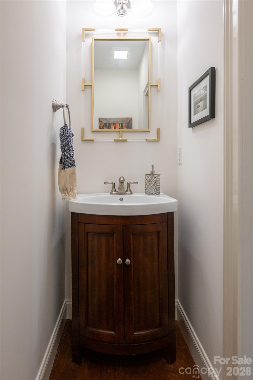 Main-level half bath with furniture-style vanity, located off the main living area. - 17 Asher Lane, Arden