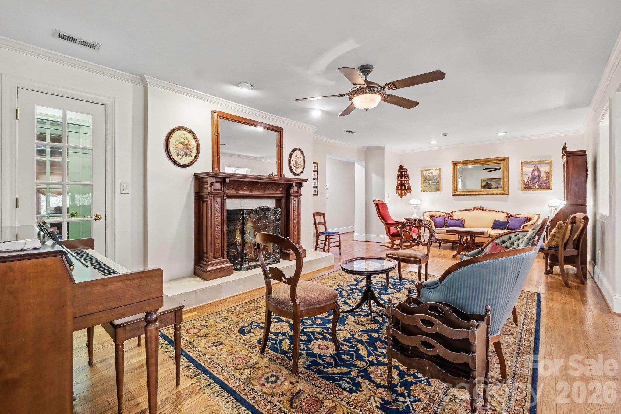 Versatile living/dining/flex area features a display closet and gas fireplace with a beautiful custom mantle - 746 Grandview Drive NE, Concord