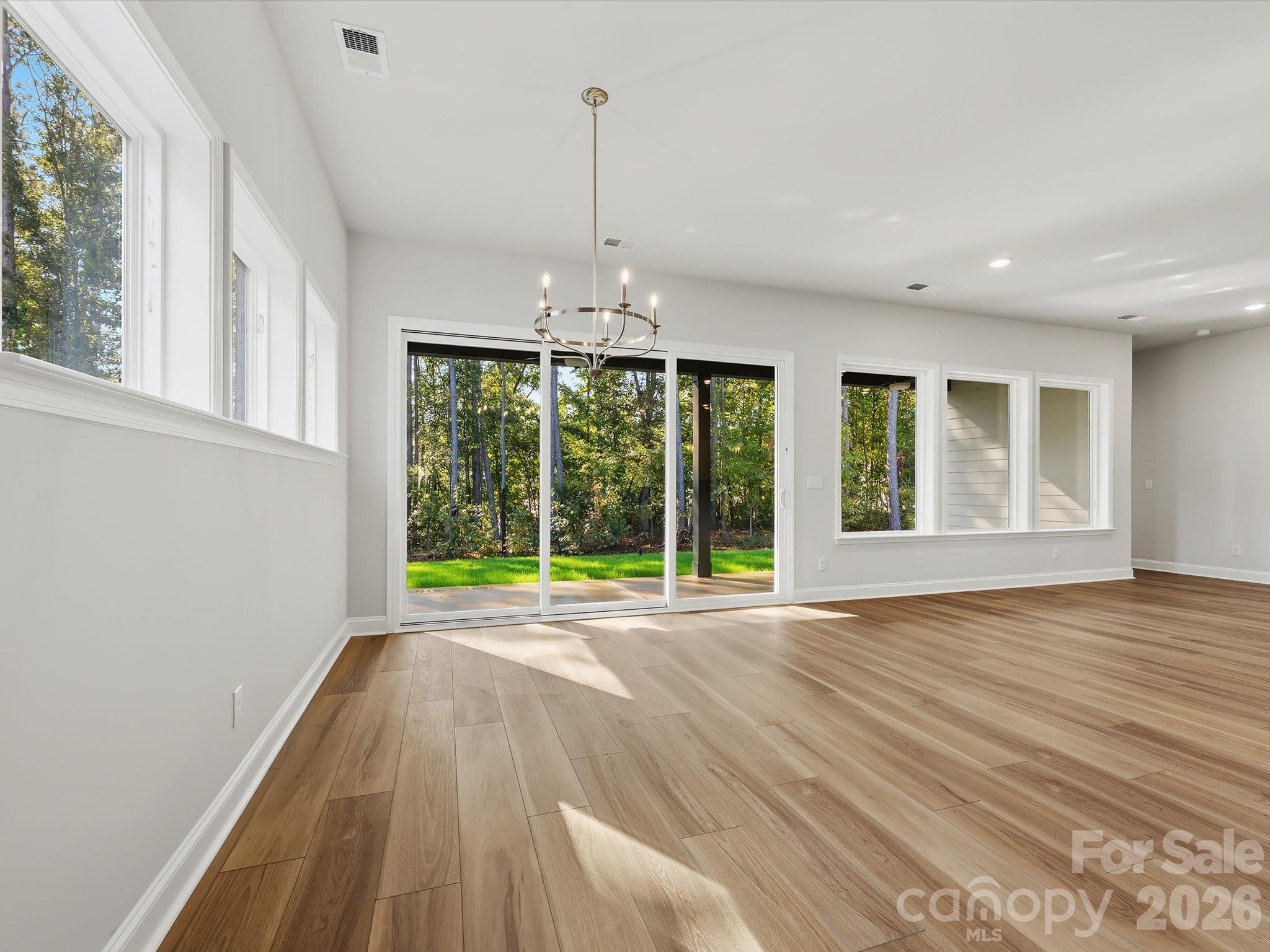 Dining and Family Room. 12 foot telescoping door opens to extended covered patio. - 344 Portree Street, Rock Hill