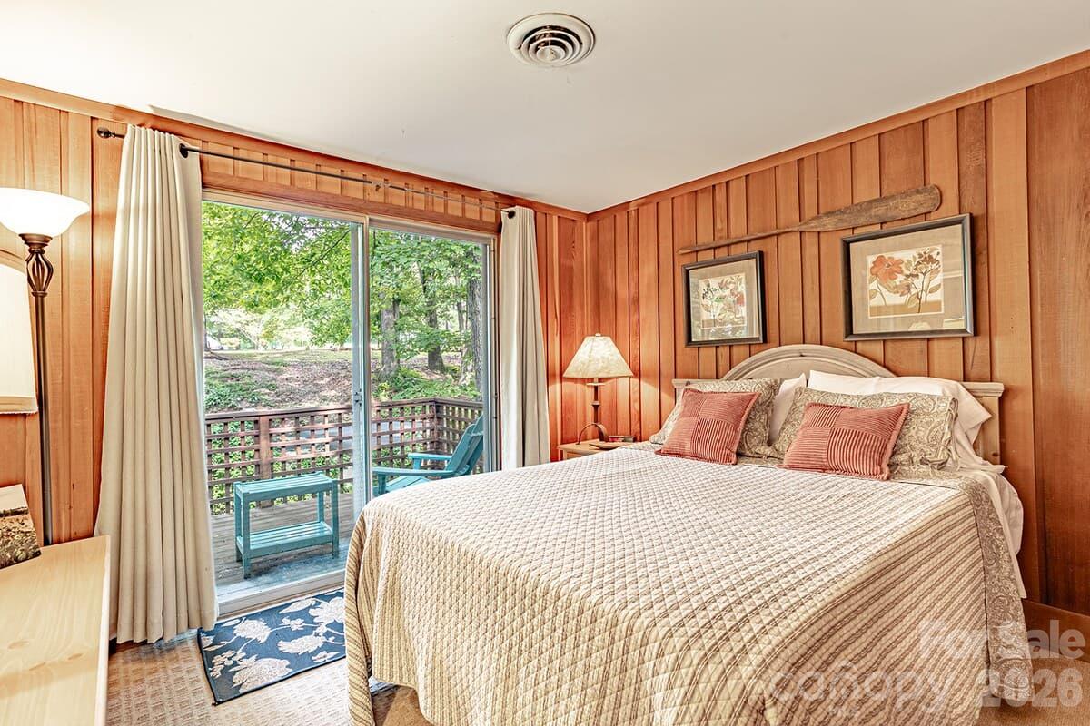 Second bedroom on upper level with private balcony - 208 N West Lake Drive, Lake Lure