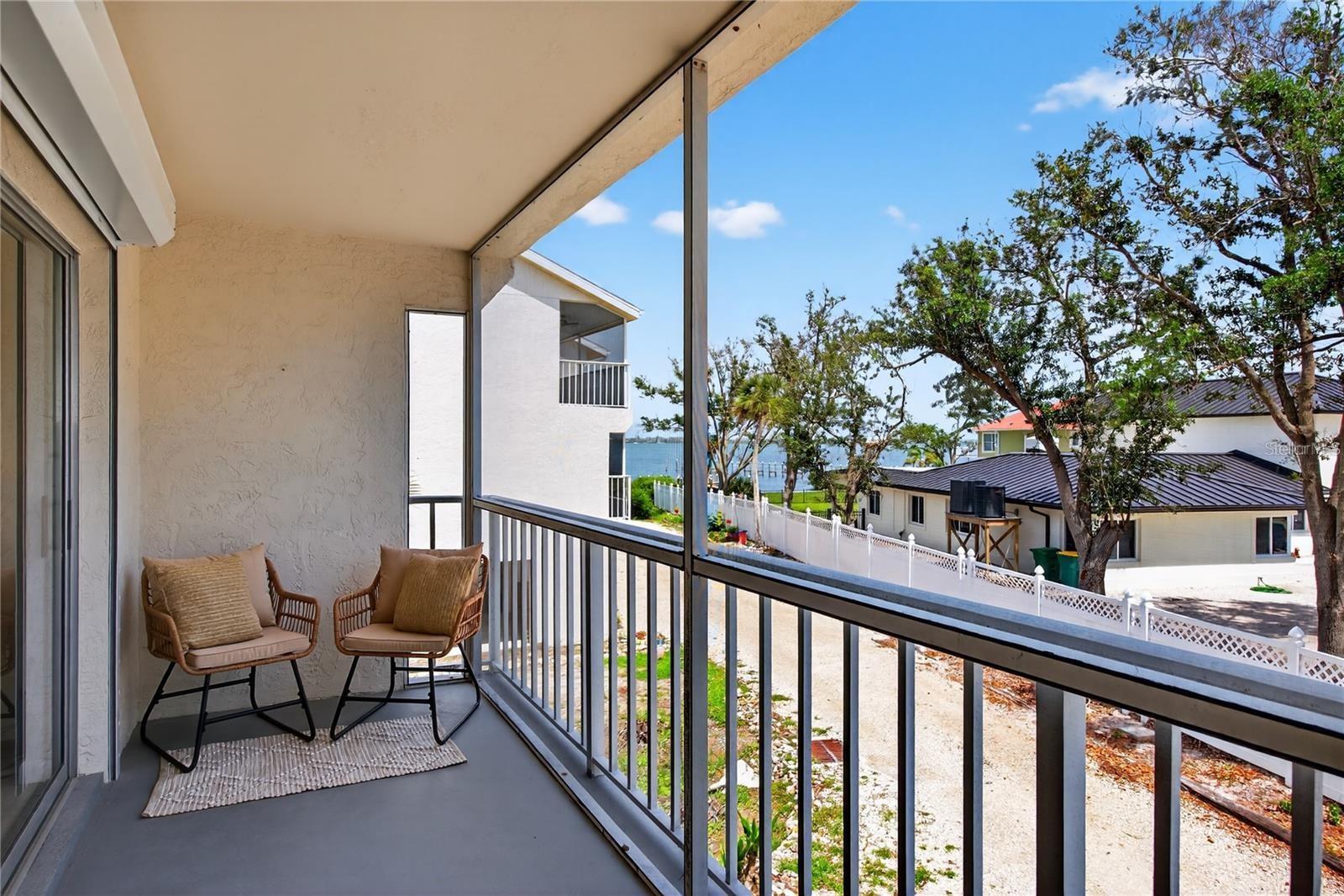 Lanai Directly Off of Living Room and Primary Bedroom with Peekaboo Views to Lemon Bay - 5031 N BEACH RD #118, ENGLEWOOD