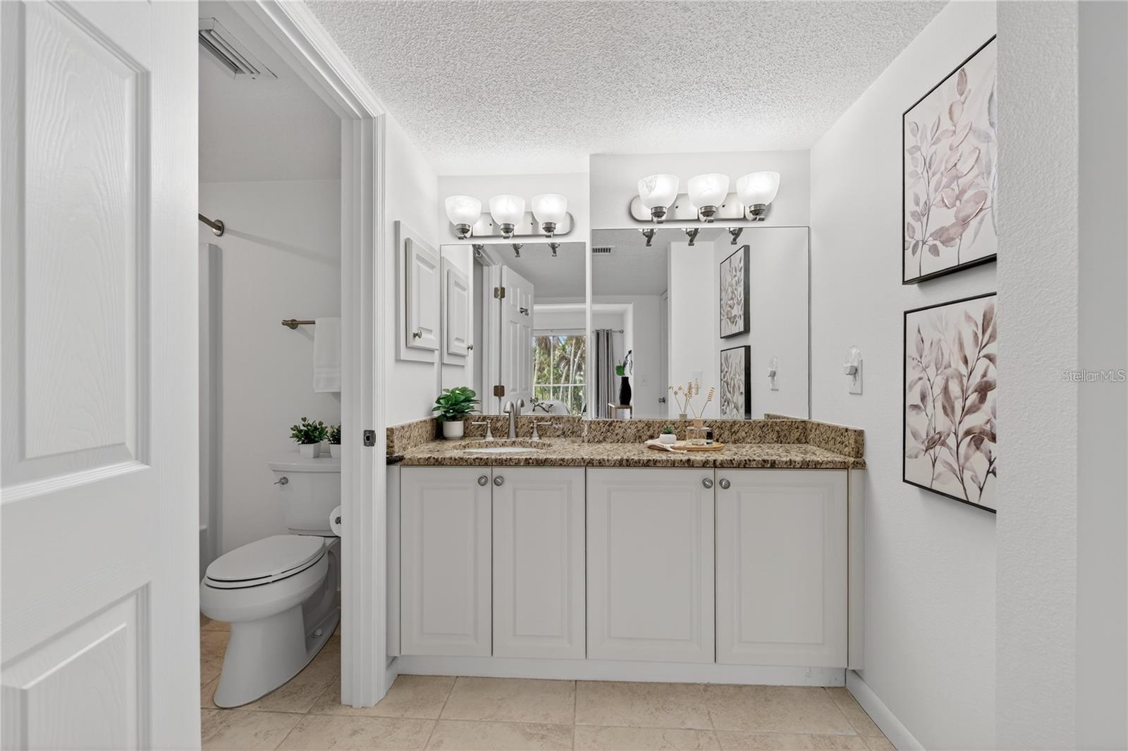 Primary Bathroom with Large Granite-Topped Vanity - 5031 N BEACH RD #118, ENGLEWOOD