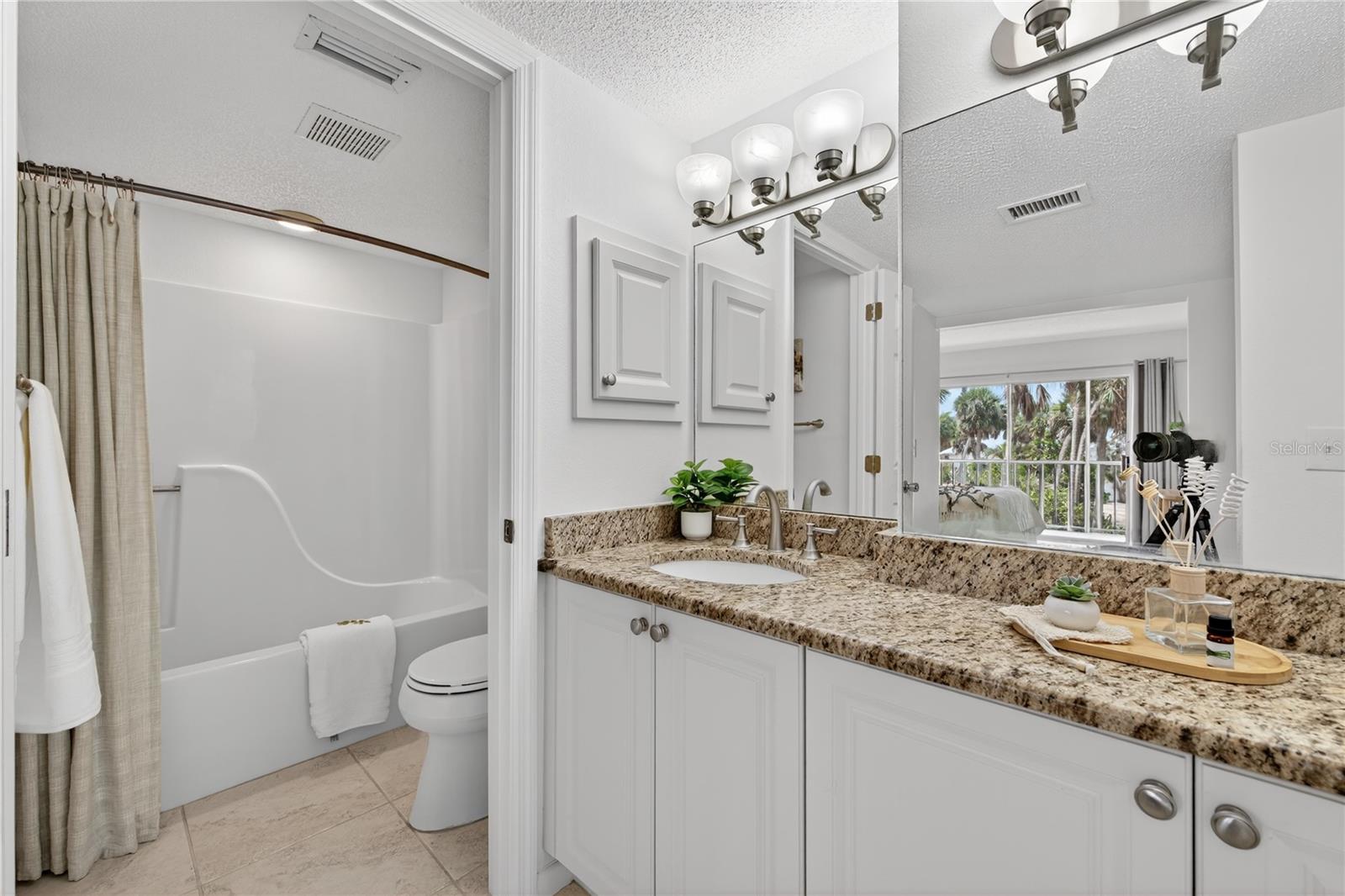 Tub and Shower Combination in Primary Ensuite Bedroom - 5031 N BEACH RD #118, ENGLEWOOD