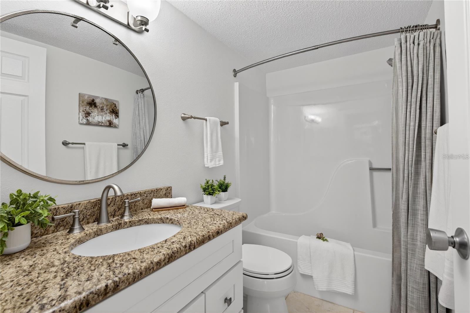 Second Bathroom with Granite-Topped Vanity and Tub and Shower Combination - 5031 N BEACH RD #118, ENGLEWOOD