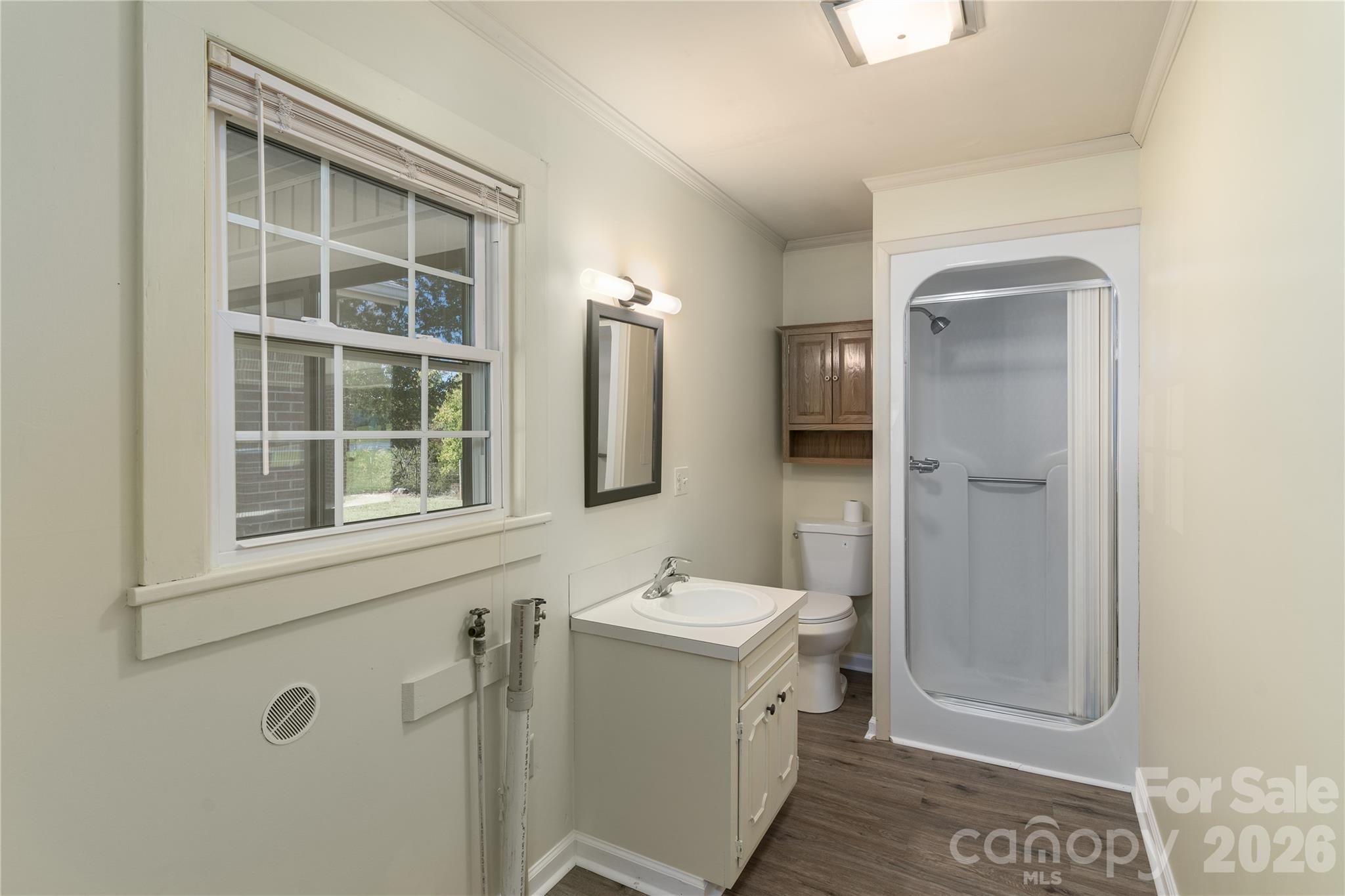 **New update** AFTER- Freshly painted bathroom, new LVP flooring, new mirror & light. Dryer vent has new cover. - 5271 Harris Farm Road, Hickory