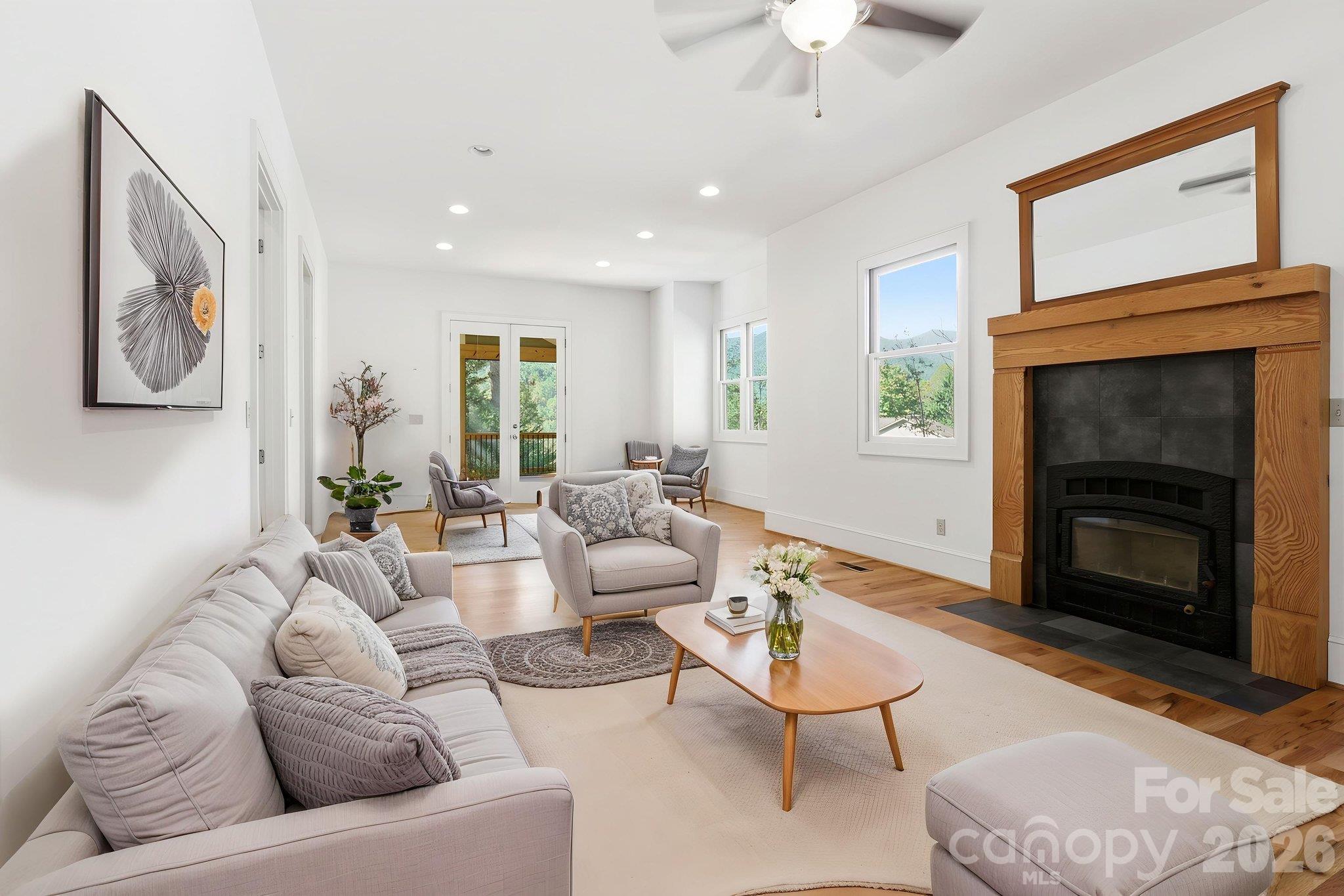 Staged Open Living/Dining Room with hardwood floors and fireplace insert - 39 Williams Cove Road, Black Mountain