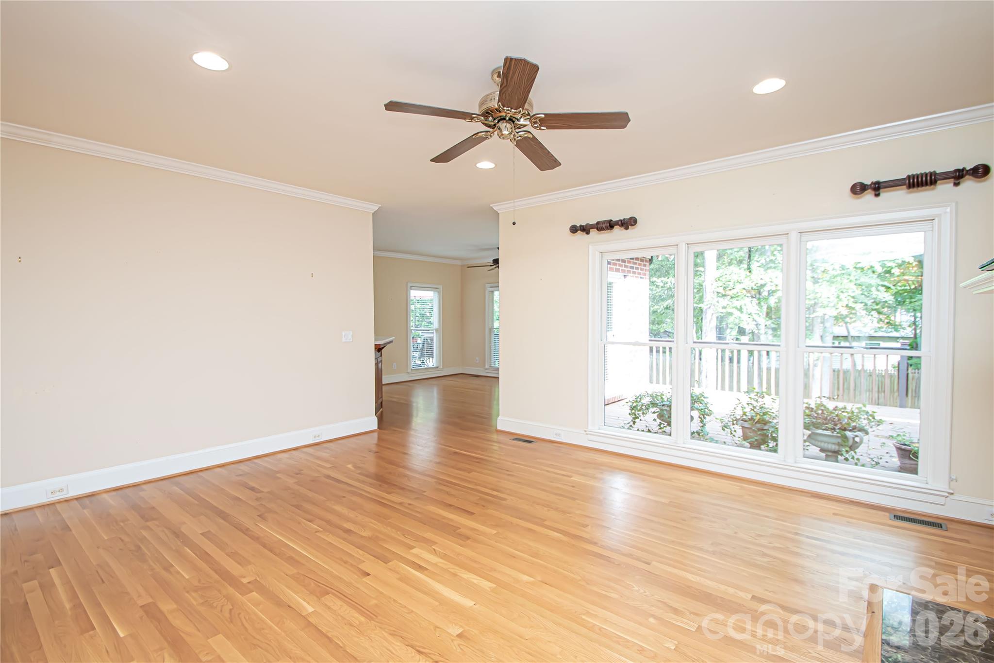 LIVING ROOM 20'x15': (pic taken from fireplace) view to main floor flex and big windows providing awesome natural light -facing the back deck. Recess lights. Ceiling Fan also pre wired for a light. - 5480 Glen Forest Drive, Charlotte