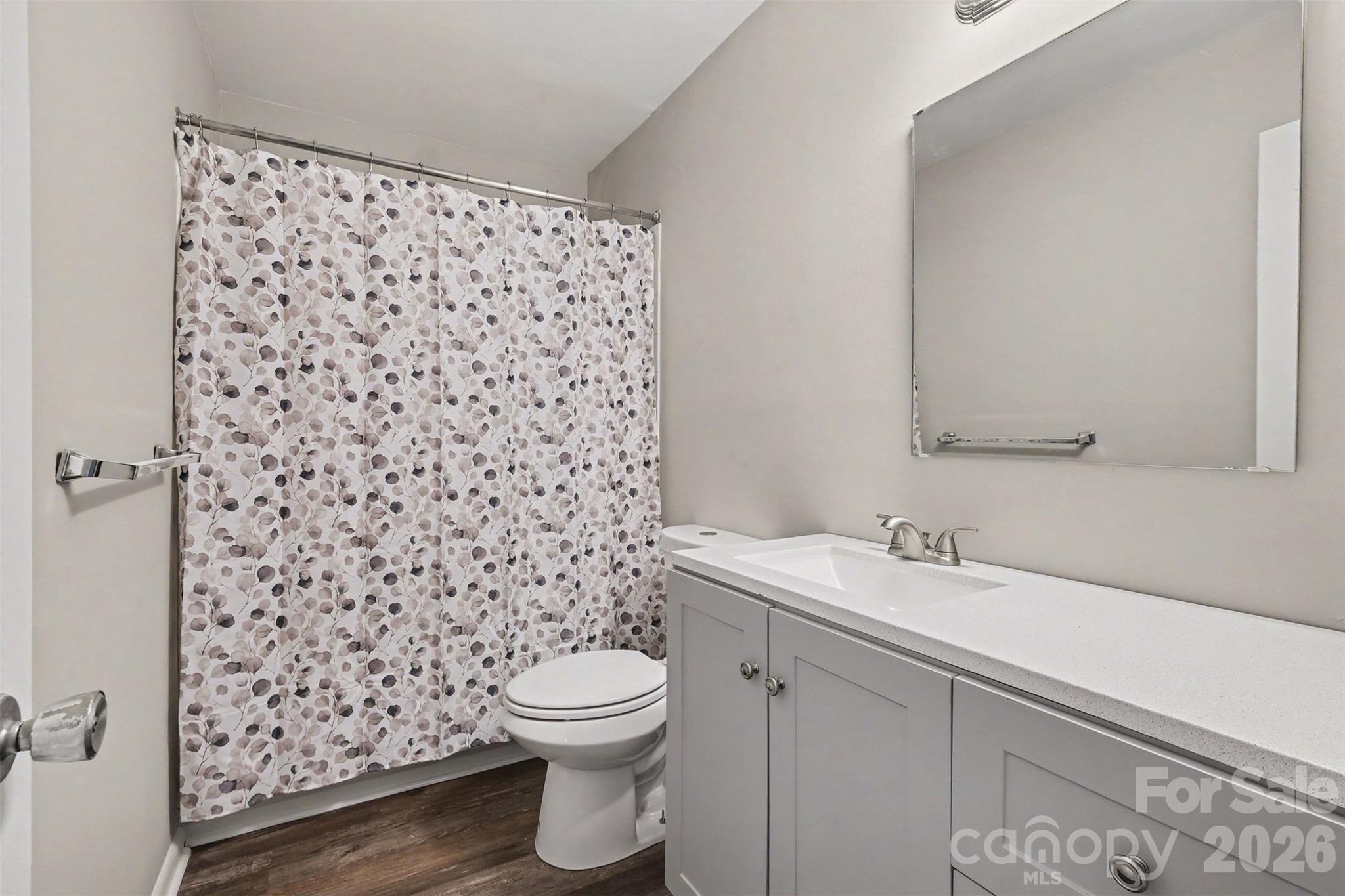 RENOVATED BATHROOM WITH NEW VANITY, TOILET AND RESURAFCED BATHTUB - 3201 Heathstead Place, Charlotte