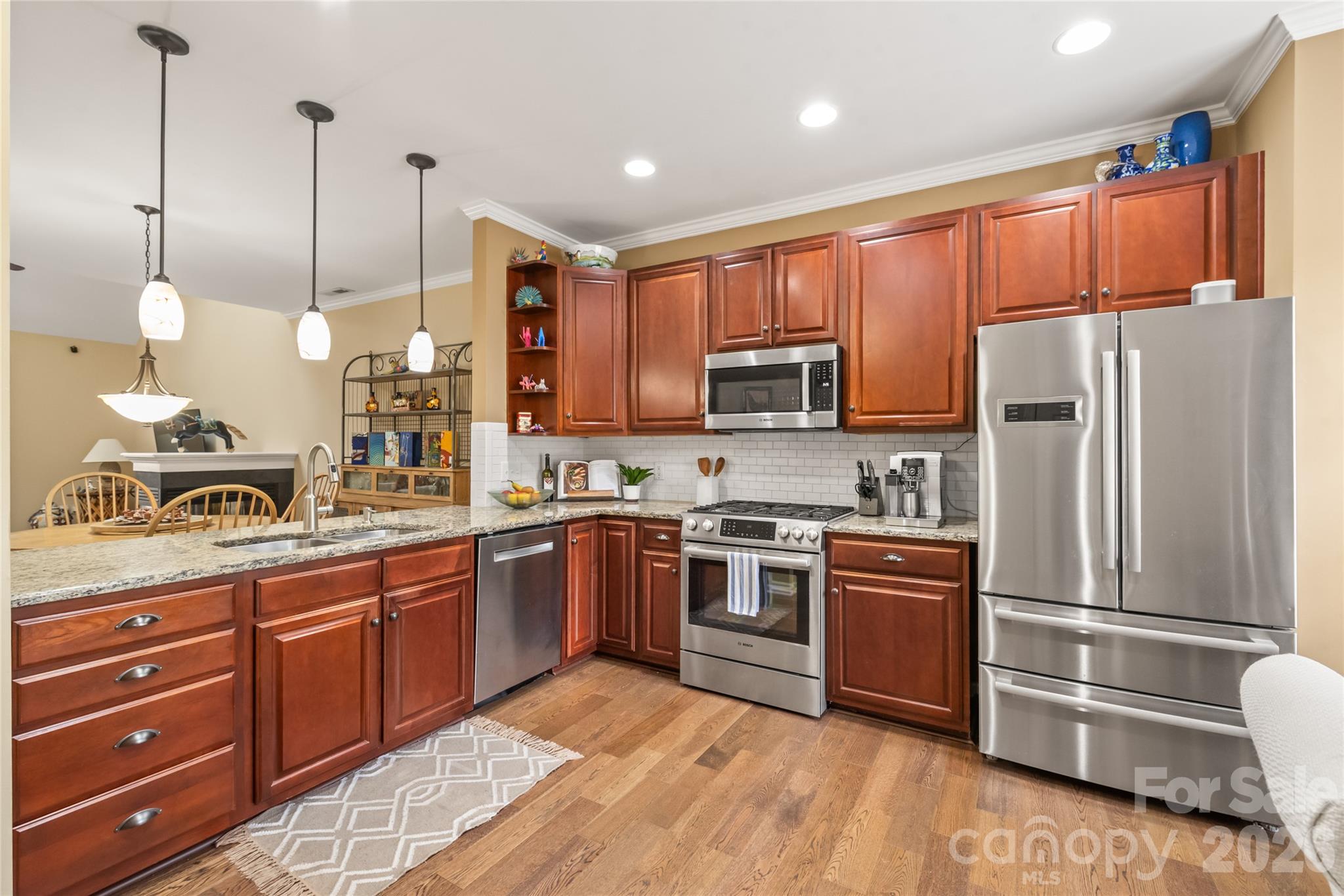 Updated Kitchen: Equipped with rich granite countertops and high-end Bosch stainless steel appliances. - 4780 Grier Farm Lane, Charlotte