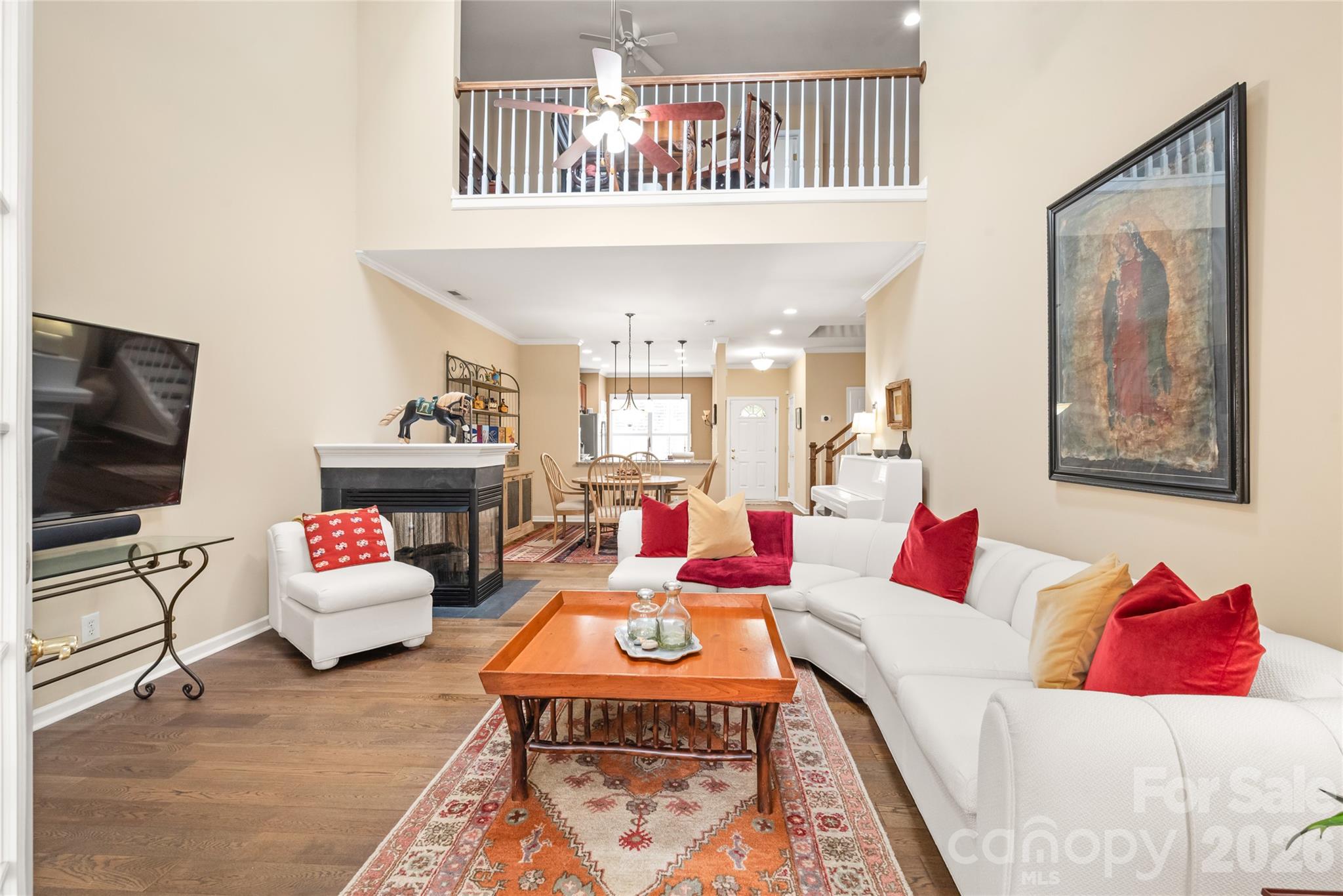 Soaring, light-filled, and spacious! Vaulted ceilings with updated skylights elevate the main living room, while the open loft above creates a bright, architectural focal point. - 4780 Grier Farm Lane, Charlotte