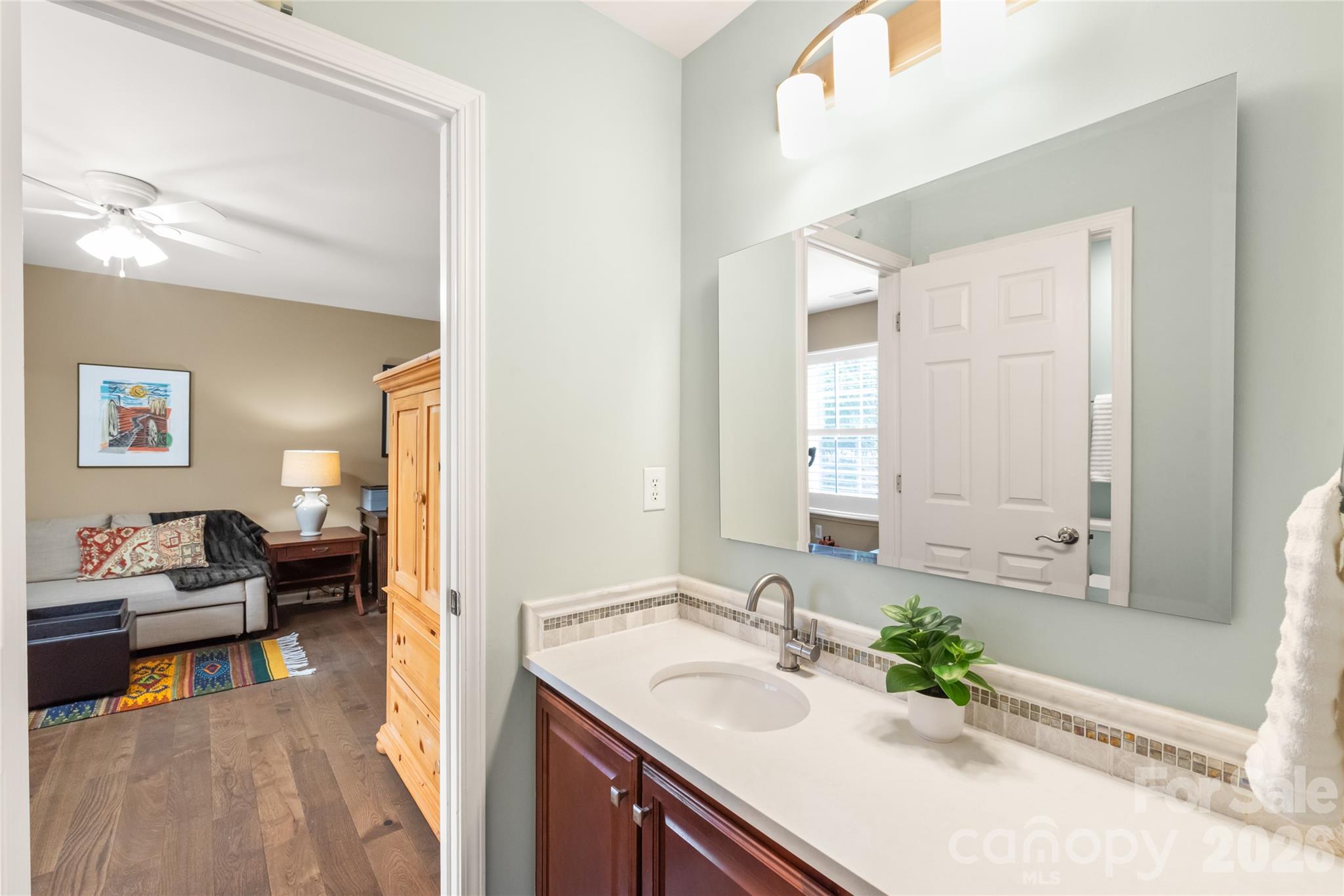 Perfectly placed for comfort and privacy! Situated right between bedrooms two and three, this updated Jack and Jill bathroom offers seamless convenience with quartz countertops and custom tile finishes. - 4780 Grier Farm Lane, Charlotte