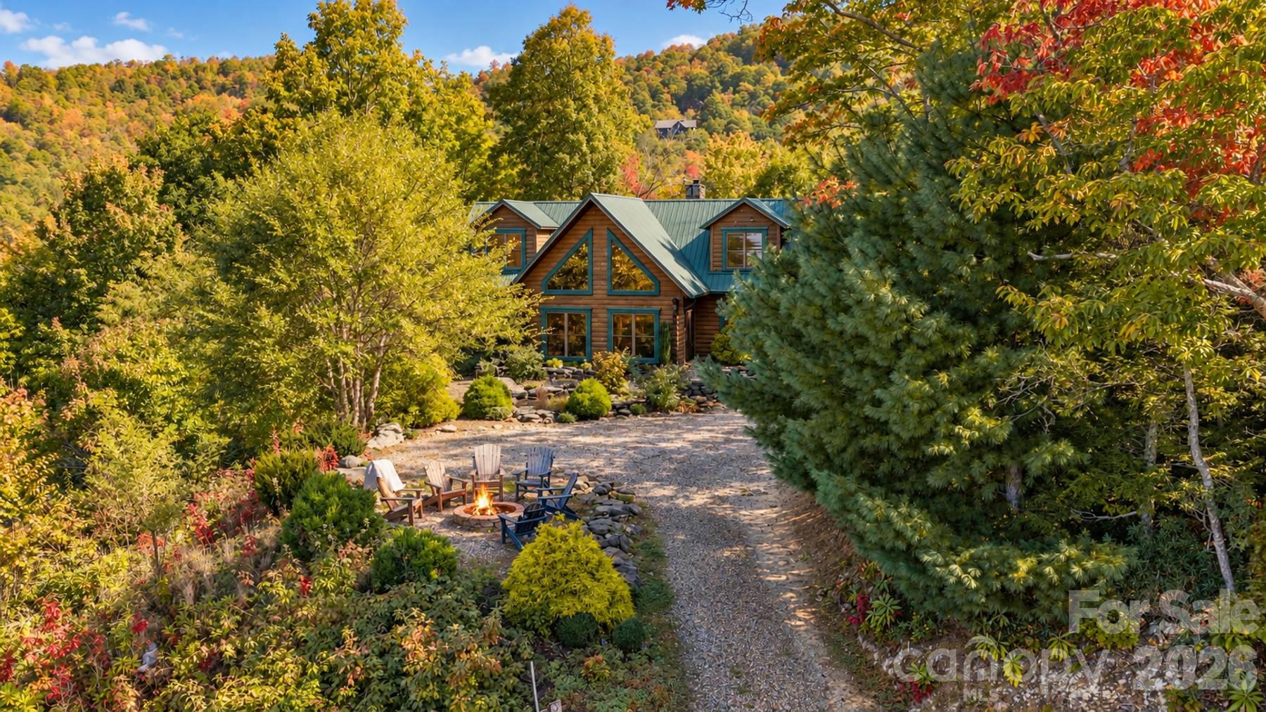 Aerial view of the log home, firepit and fall color with mountain backdrop - 18 Fairway Run, Bryson City