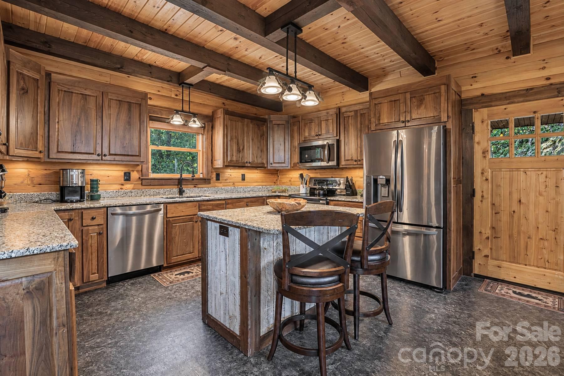 Kitchen with island seating, granite and stainless appliances - 18 Fairway Run, Bryson City
