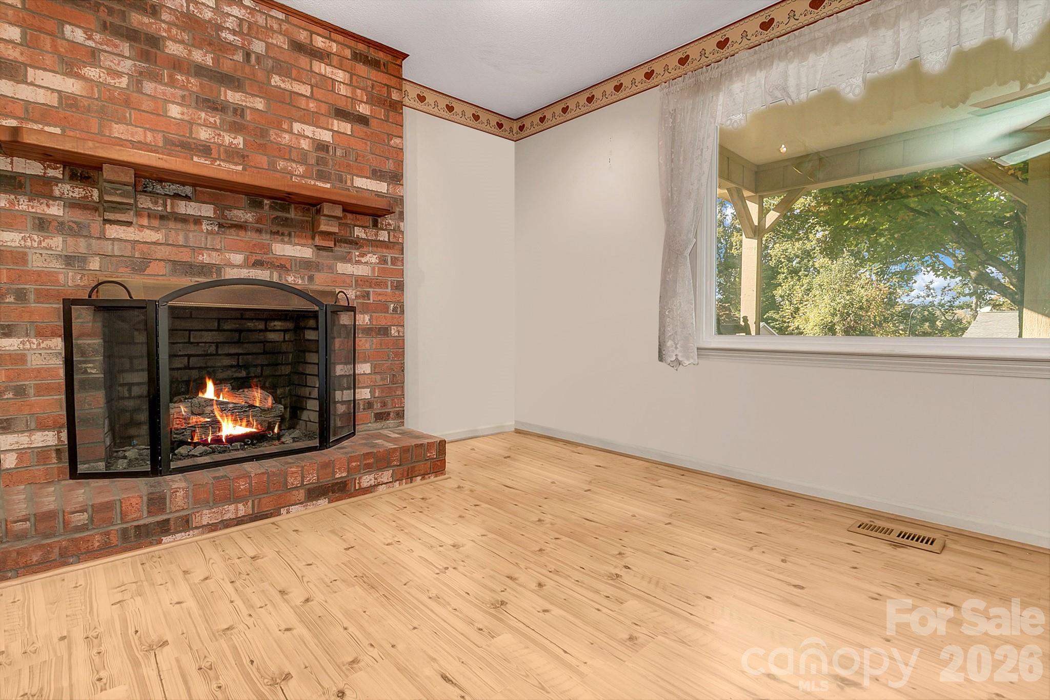Fireplace w/bay window & natural lighting in room - 1 Dewberry Drive, Hendersonville