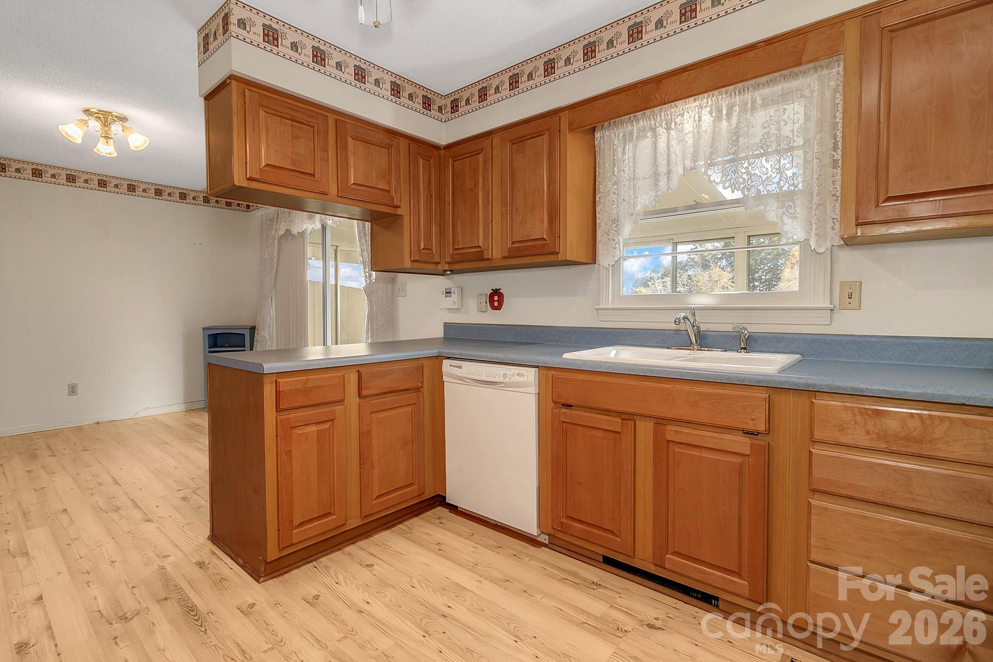 Kitchen w/window over sink & looking into dining area - 1 Dewberry Drive, Hendersonville