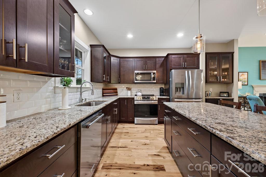 With creamy white subway tile, dark cabinets and granite, it's a classy little kitchen! - 98 Langwell Avenue, Asheville