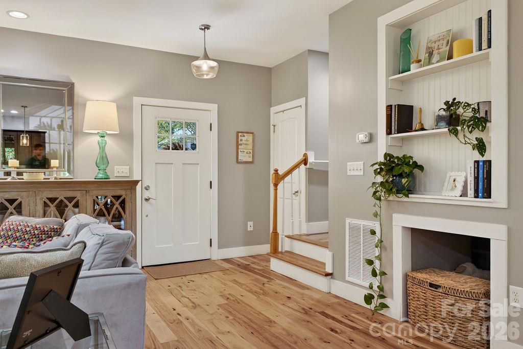 A sweet little built-in and a basket nook add a little extra charm to the entry. - 98 Langwell Avenue, Asheville