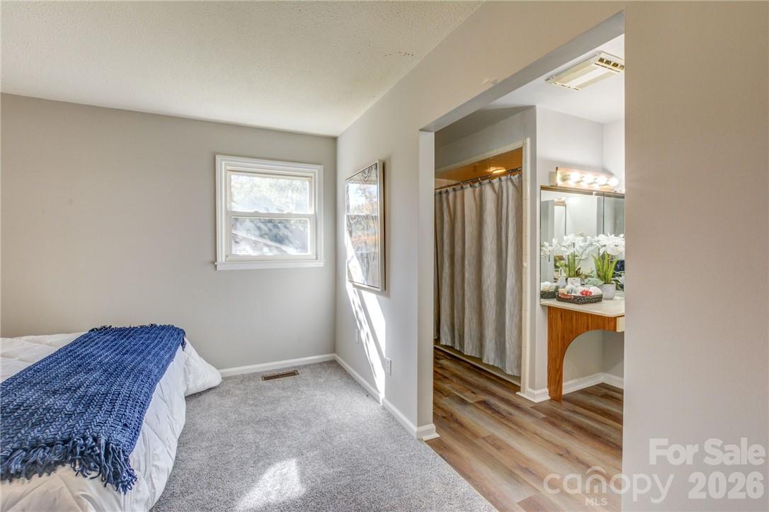 Primary bedroom opens to bathroom with tub and separate shower - 311 Bell Road, Kings Mountain