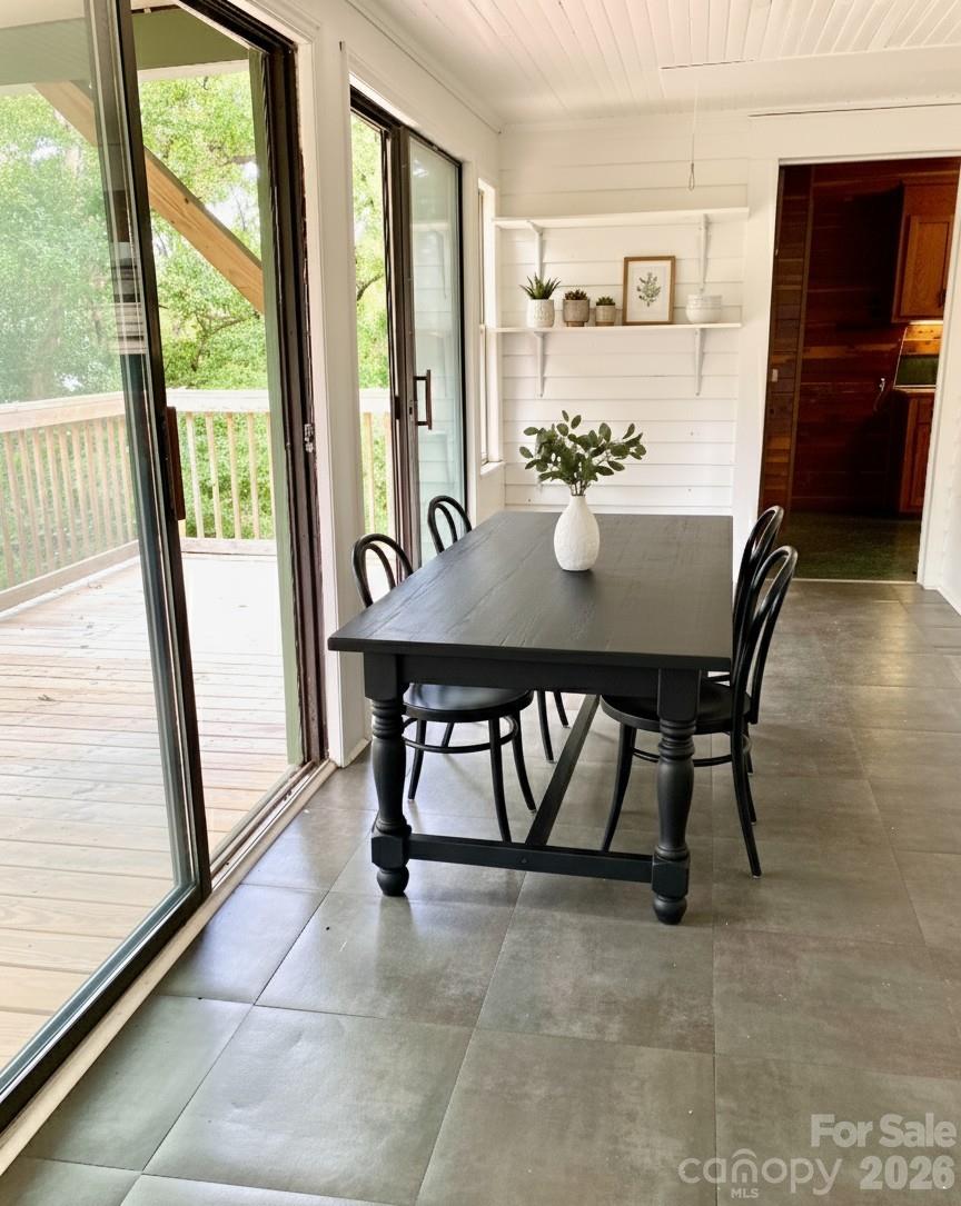 Rear porch just off the kitchen has double slider doors that open to deck and has washer/ dryer hookup. - 326 S 3rd Street, Albemarle