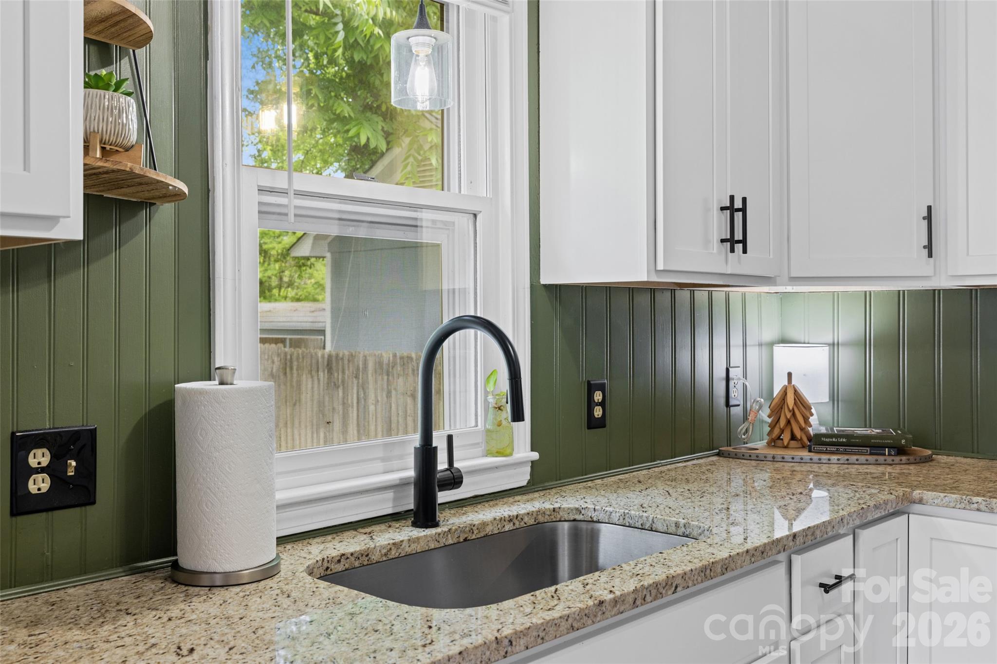 Updated kitchen featuring a modern black faucet, stainless steel sink, and a window overlooking the outdoors. - 231 E Jefferson Street, York