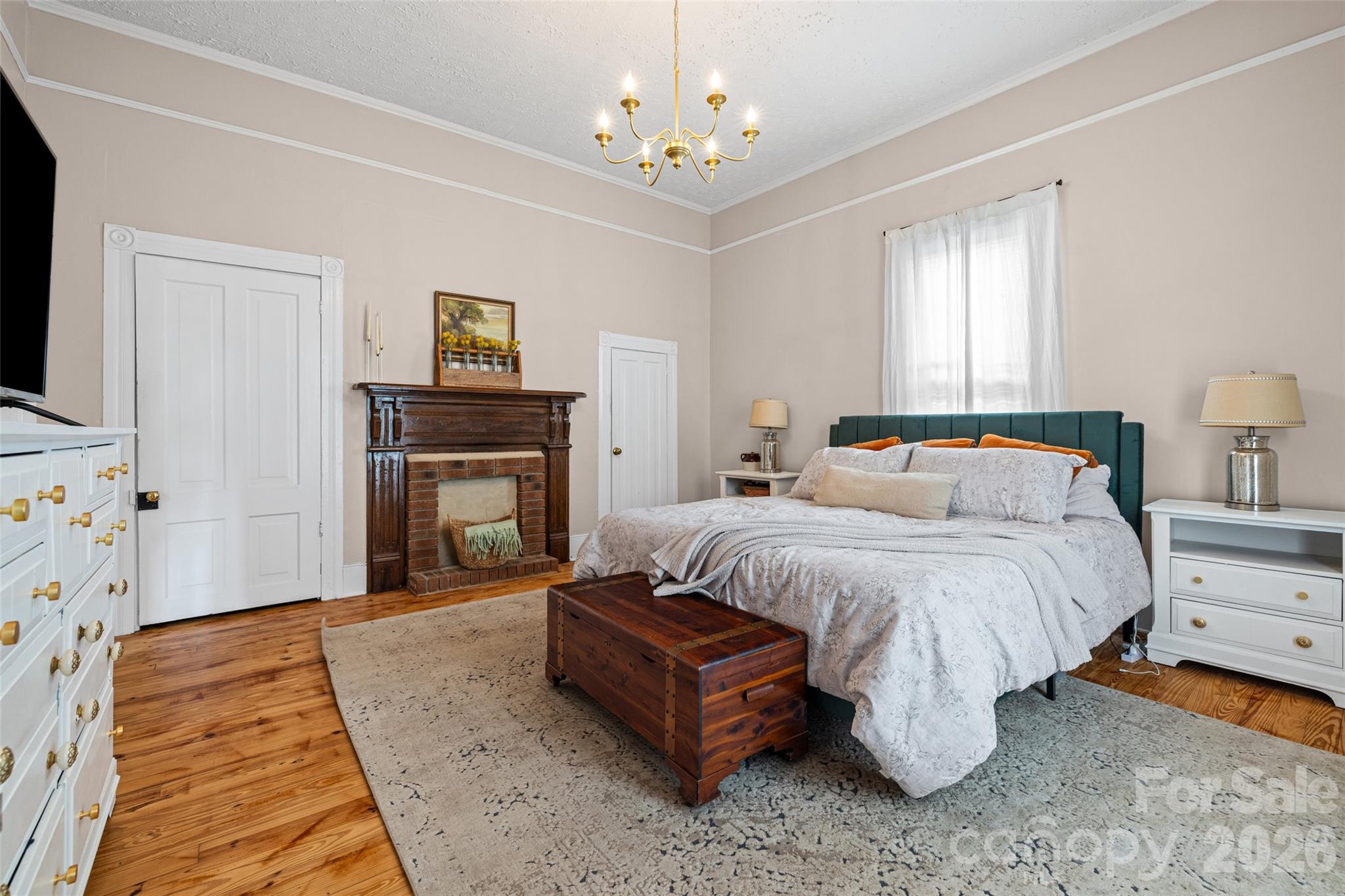 Spacious primary bedroom featuring refinished hardwood floors, tall ceilings, and abundant natural light. - 231 E Jefferson Street, York