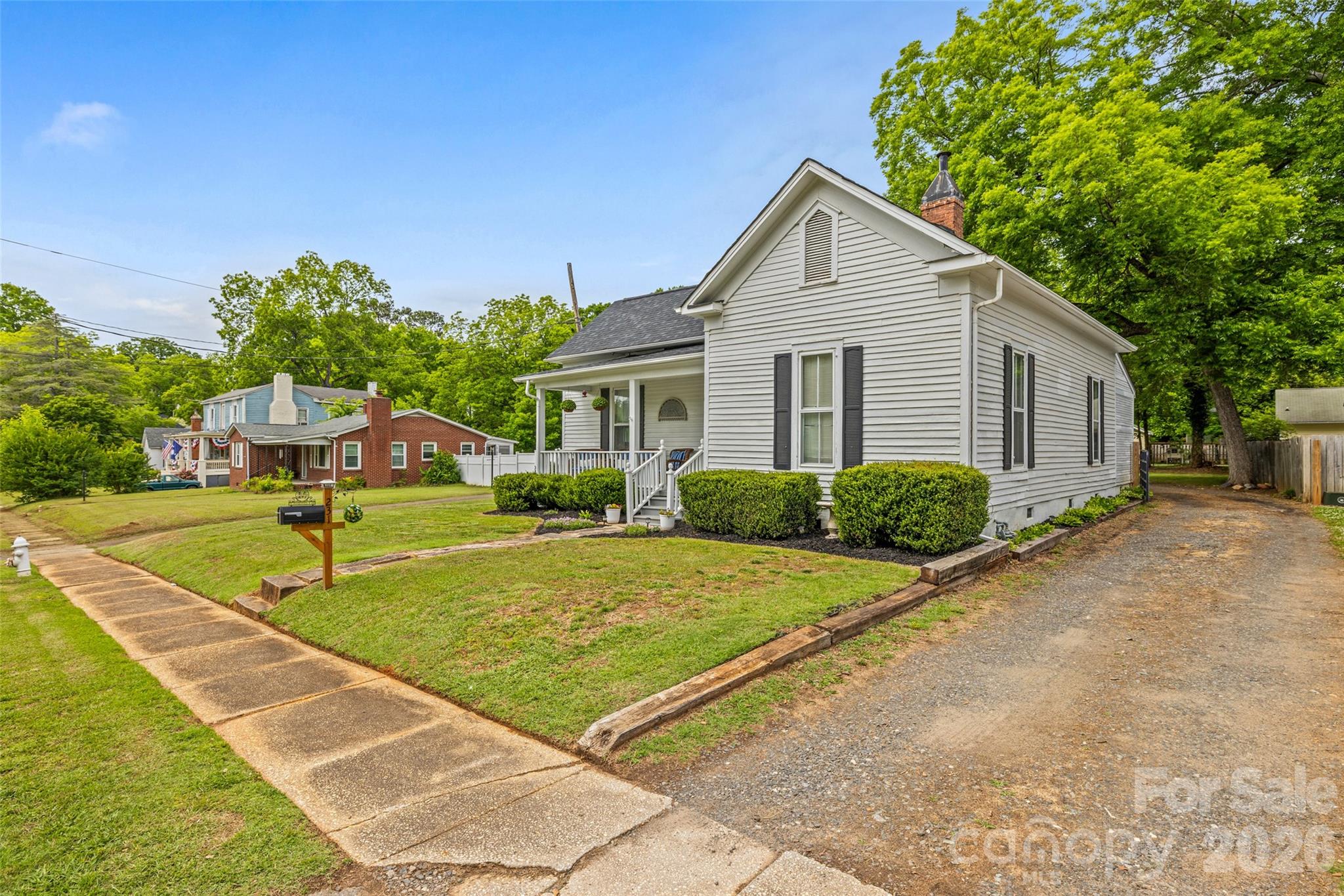 Charming setting with mature landscaping, welcoming front porch, and convenient side driveway. - 231 E Jefferson Street, York
