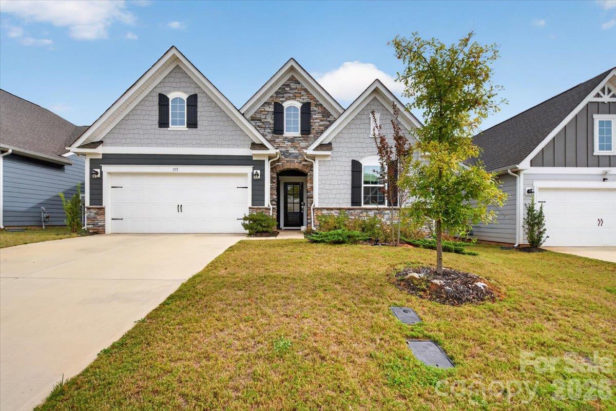 Lush, well-maintained front lawn with a welcoming walkway. - 155 White Apple Way, Statesville