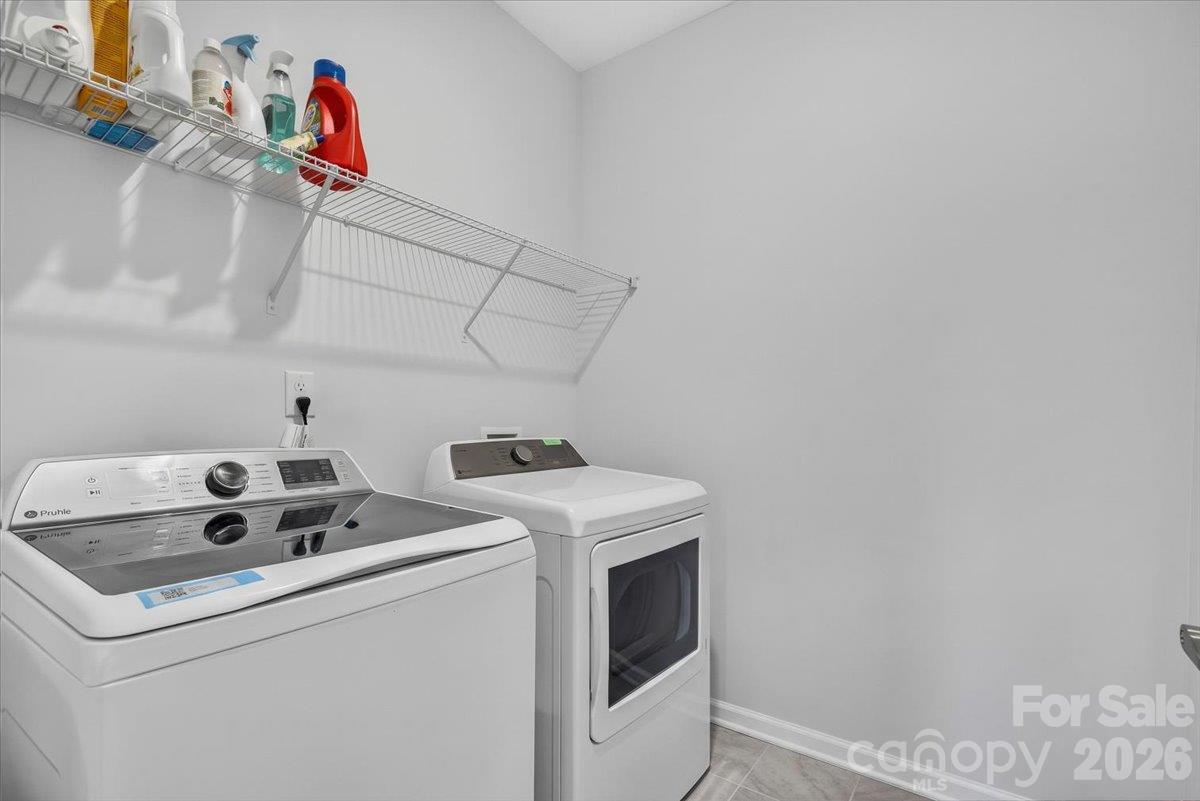 Convenient dedicated laundry area equipped with overhead wire shelving for excellent organization and storage. - 155 White Apple Way, Statesville