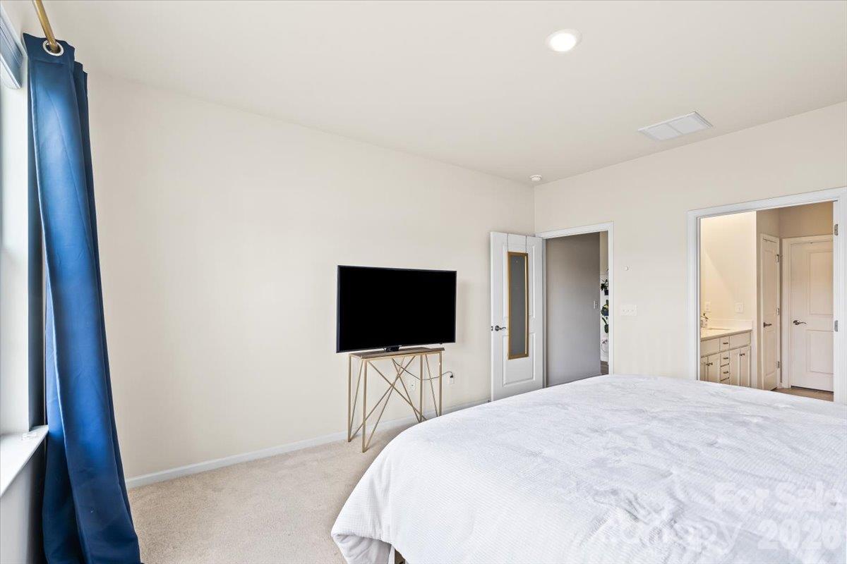 Comfortable primary bedroom offering a great layout with plenty of space for a media setup or additional furnishings. - 155 White Apple Way, Statesville