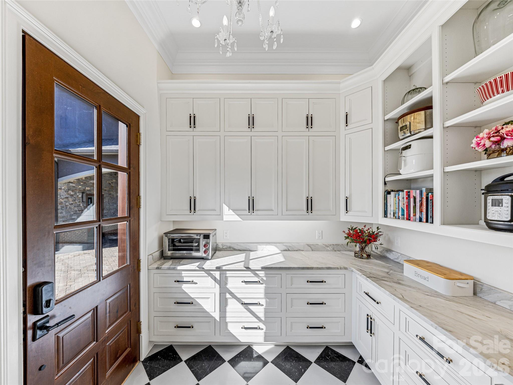 Side egress leads into pantry. Great storage space and plenty of additional countertop space. - 1905 White Tree Trail, Arden