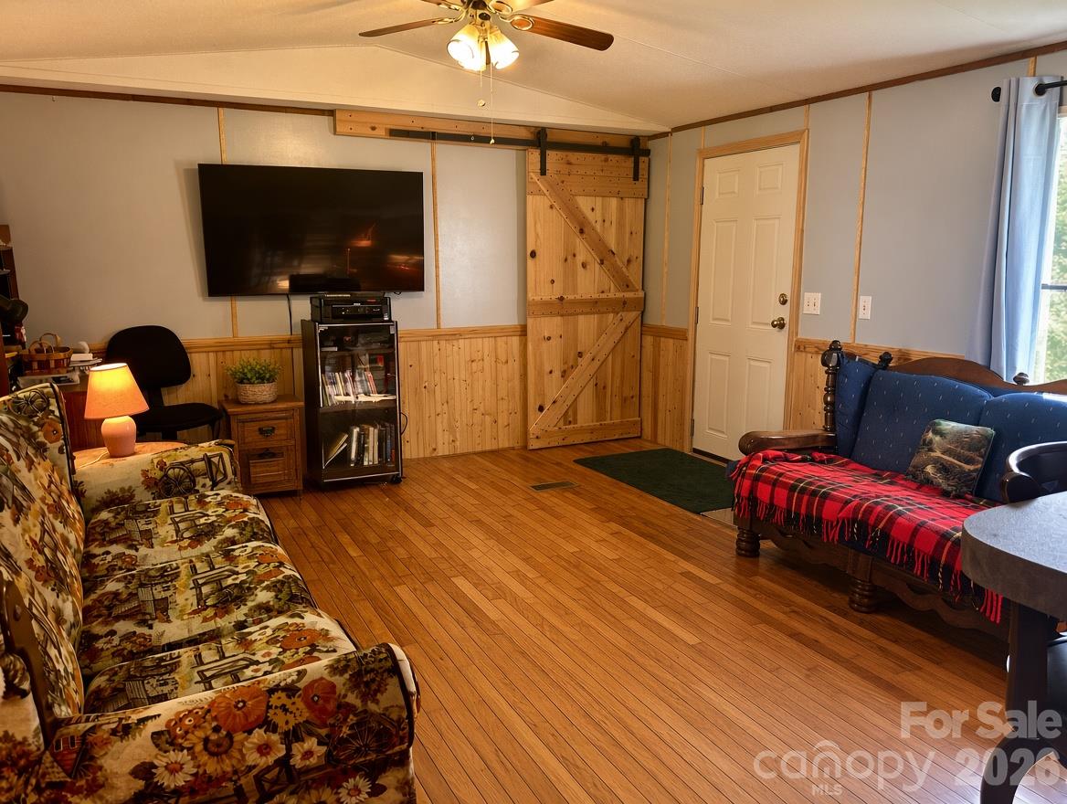 Living Room - Hardwood floors, rustic barn door - 492 Chestnut Mountain Road, Spruce Pine