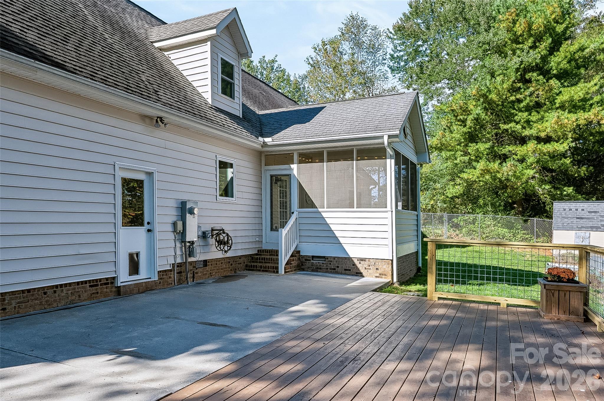 Patio area looking into sunroom - 2122 N Rugby Road, Hendersonville