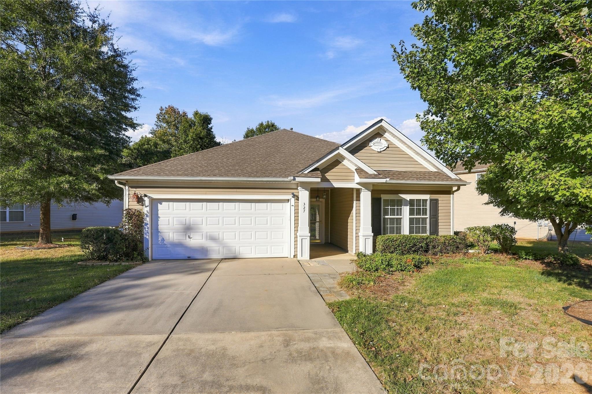 A covered front entry and an easy single-level layout make every arrival feel welcoming. - 327 Annaberg Lane, Monroe