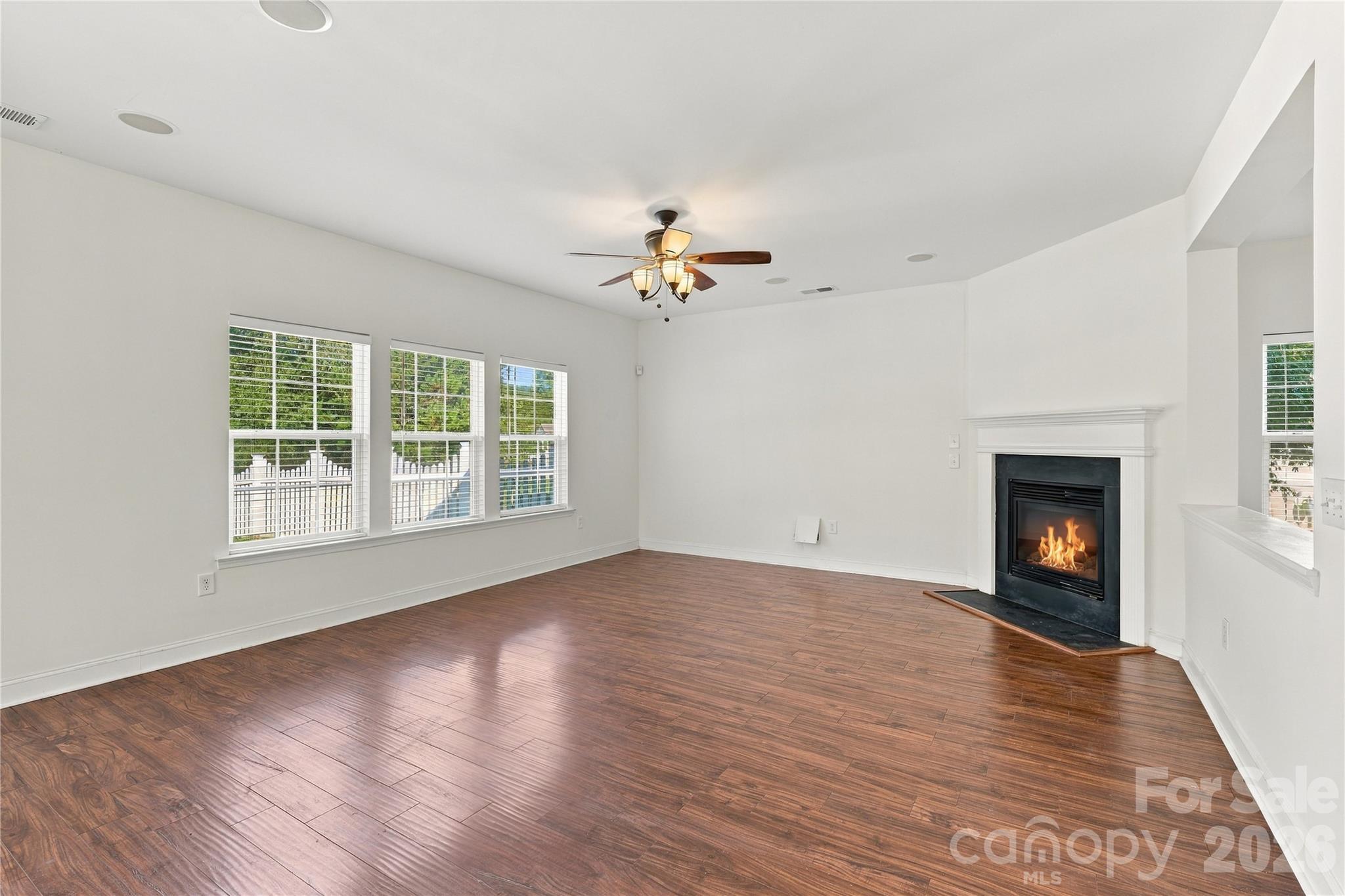The fireplace anchors the living room, with plenty of space to arrange your furniture. - 327 Annaberg Lane, Monroe