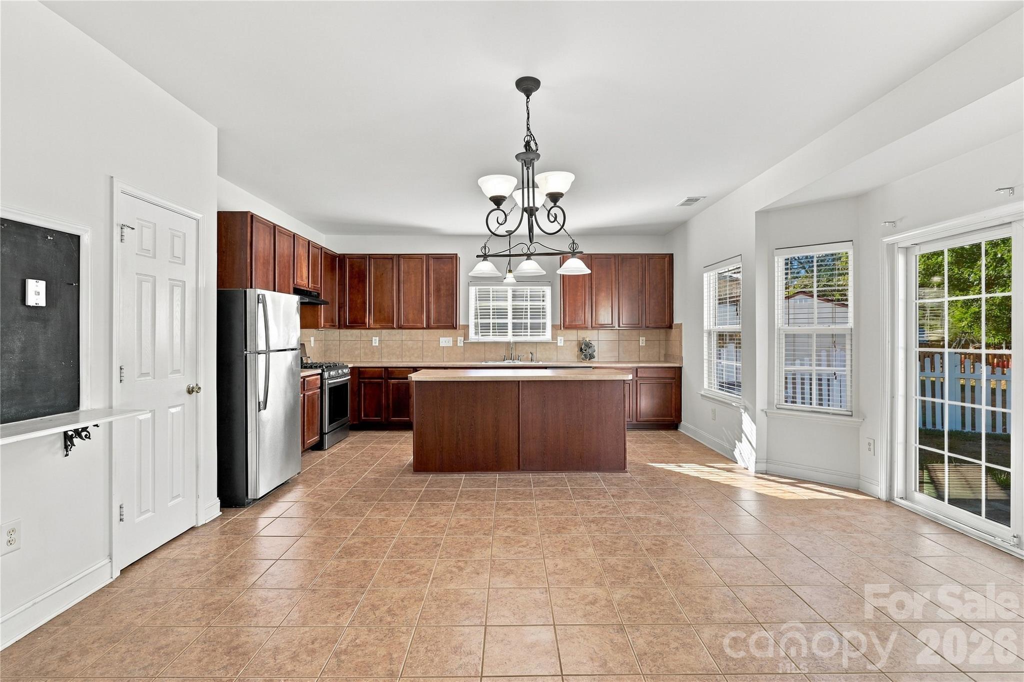 A chandelier-lit breakfast nook looks out over the yard. It's a great spot for morning coffee. - 327 Annaberg Lane, Monroe