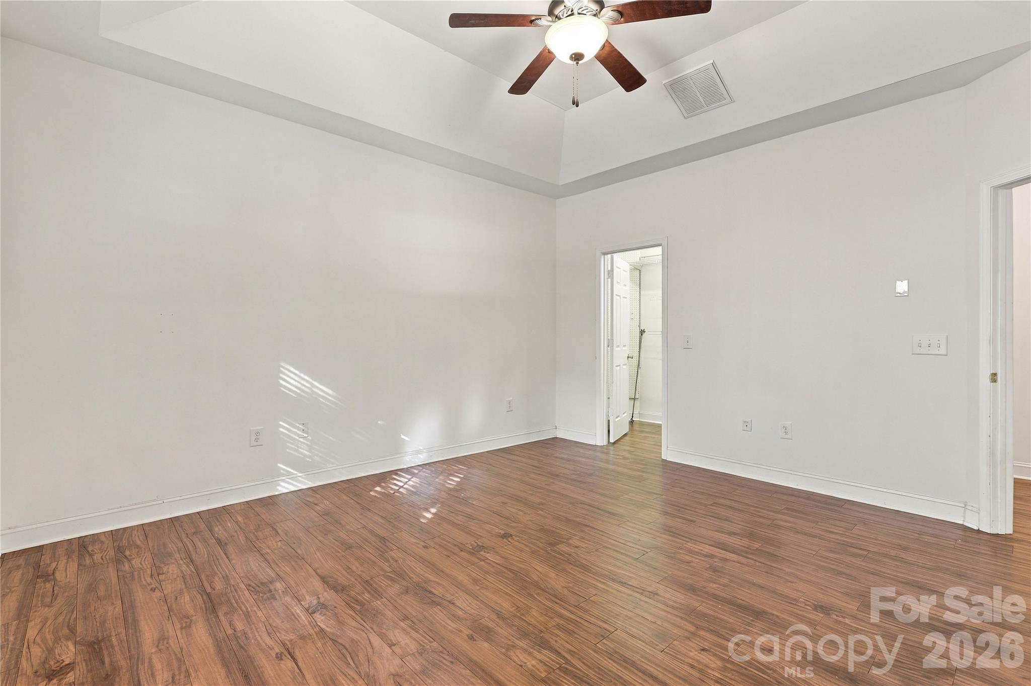 A calm, bright primary bedroom set apart from the secondary bedrooms for extra privacy. - 327 Annaberg Lane, Monroe