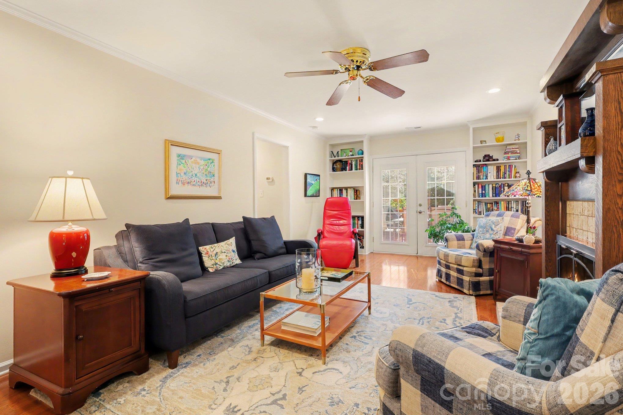 Comfortable living room with twin built in bookcases flanking the French doors going out to the deck. - 640 Heather Lane, Charlotte
