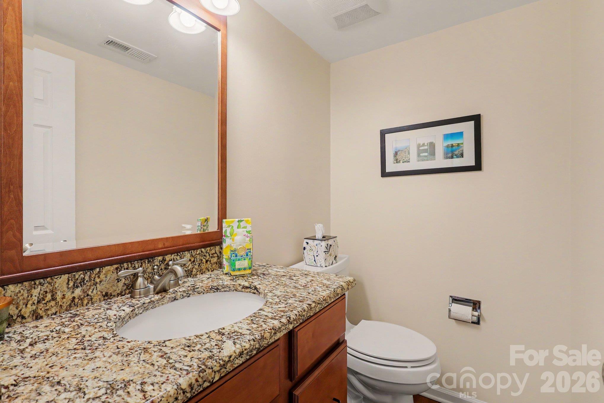 Half bathroom located on the main floor between the kitchen and living room. - 640 Heather Lane, Charlotte