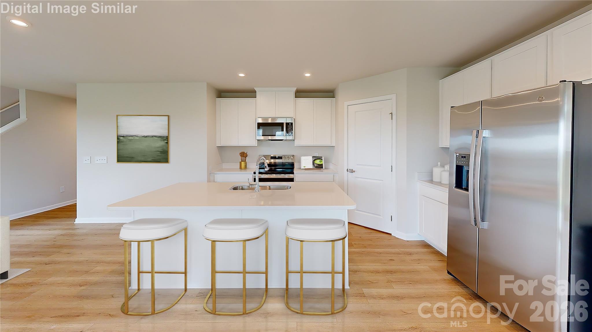 The heart of the home shines in this open-concept kitchen! A spacious island seats three—perfect for casual meals or catching up. Sleek appliances, generous counter space, and a layout built for cooking and connection make this space stylish, smart, and inviting. - 833 E Liberty Street, China Grove