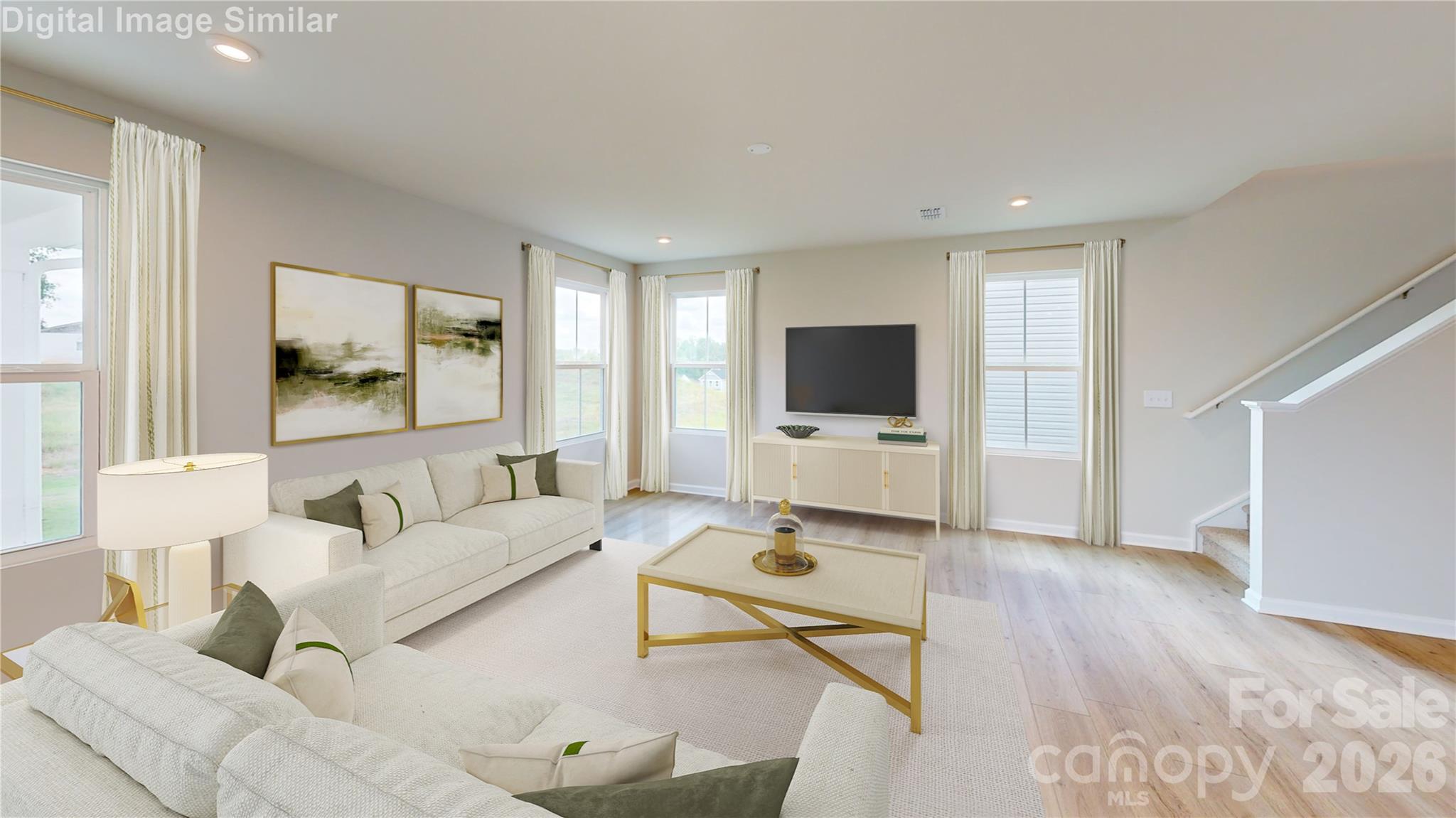 This spacious great room is filled with natural light and perfect for gatherings. Its open-concept layout keeps everyone connected—whether you're relaxing or chatting from the kitchen, the conversation flows effortlessly. - 833 E Liberty Street, China Grove