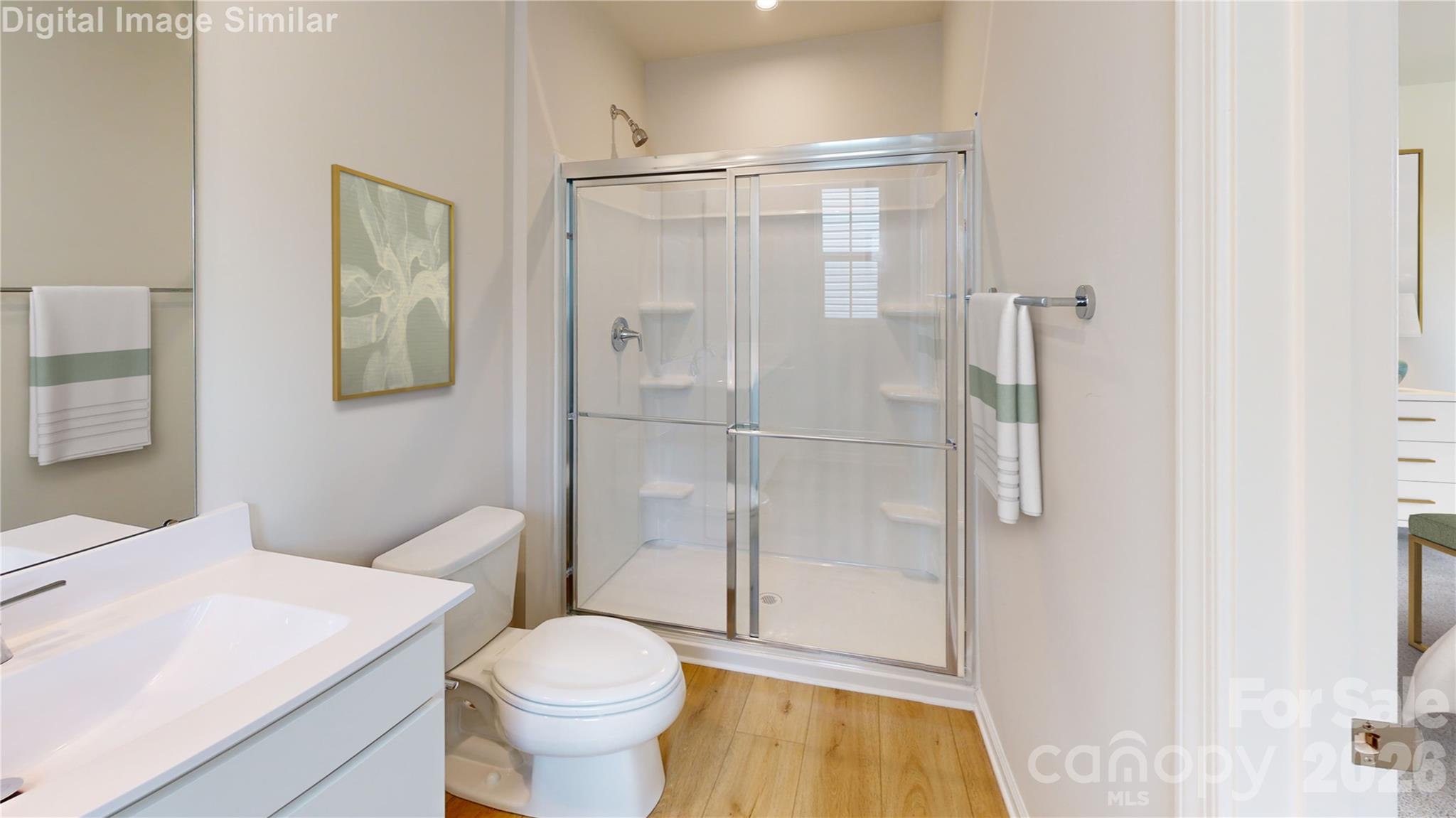 This en-suite bath is a total showstopper! A sleek framed shower door, dual vanities with matching mirrors, and tons of cabinet space make mornings effortless and evenings relaxing. Stylish, spacious, and spa-inspired—it’s your daily dose of luxury! - 833 E Liberty Street, China Grove