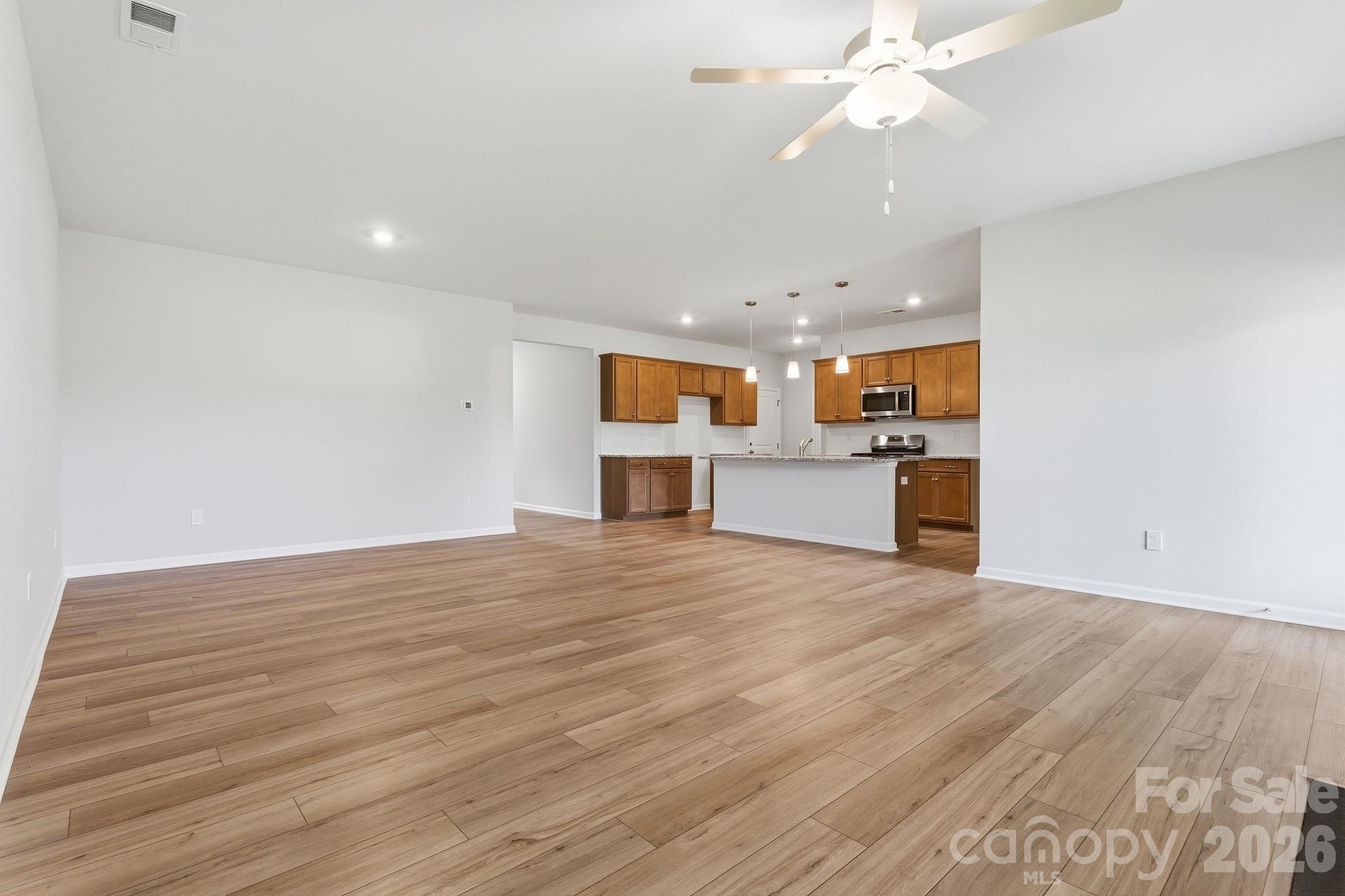 Representative Great Room into Kitchen with Island - 208 Rodeo Drive, Shelby