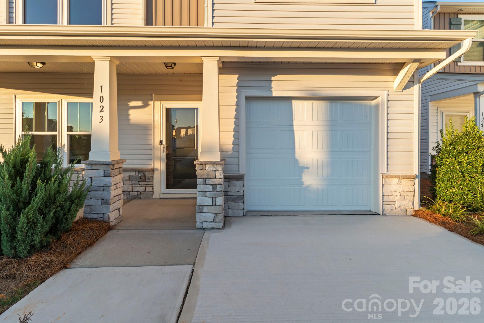 Front door with full view storm door and security camera - 1023 Freeman View Drive, Albemarle