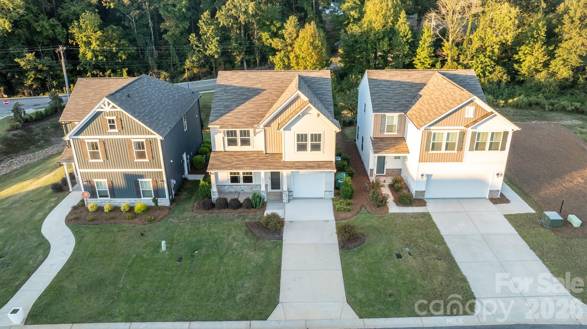 View of this home (in the middle), Community entrance in background and upscale landscaping - 1023 Freeman View Drive, Albemarle
