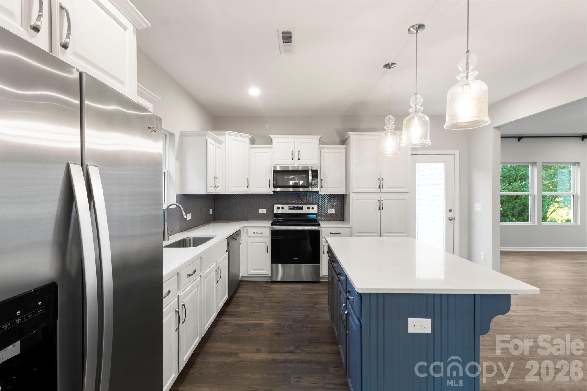 Many kitchen upgrades include stainless Whirlpool appliances, cabinets/w quartz solid surface counter tops, full backsplash, pendant light fixtures and island. - 1023 Freeman View Drive, Albemarle