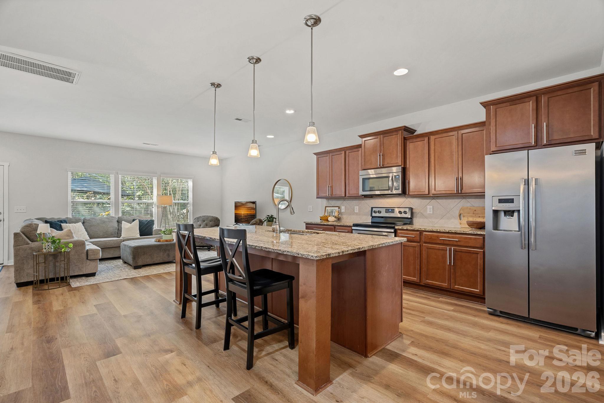 Kitchen is open to family room. Abundant cabinetry, stainless appliances - 13326 Pierre Reverdy Drive, Davidson